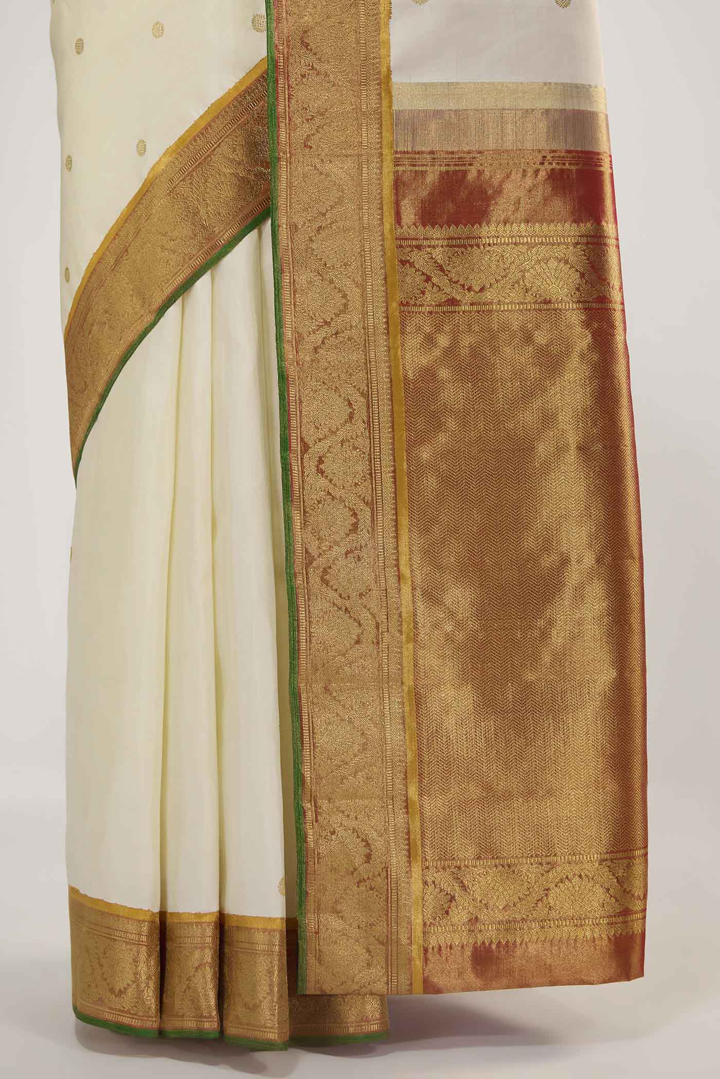 Pleats and pallu of Pure Silk Pure Zari Off White Kanchipuram Saree with Zari Butta on the body and Zari Border