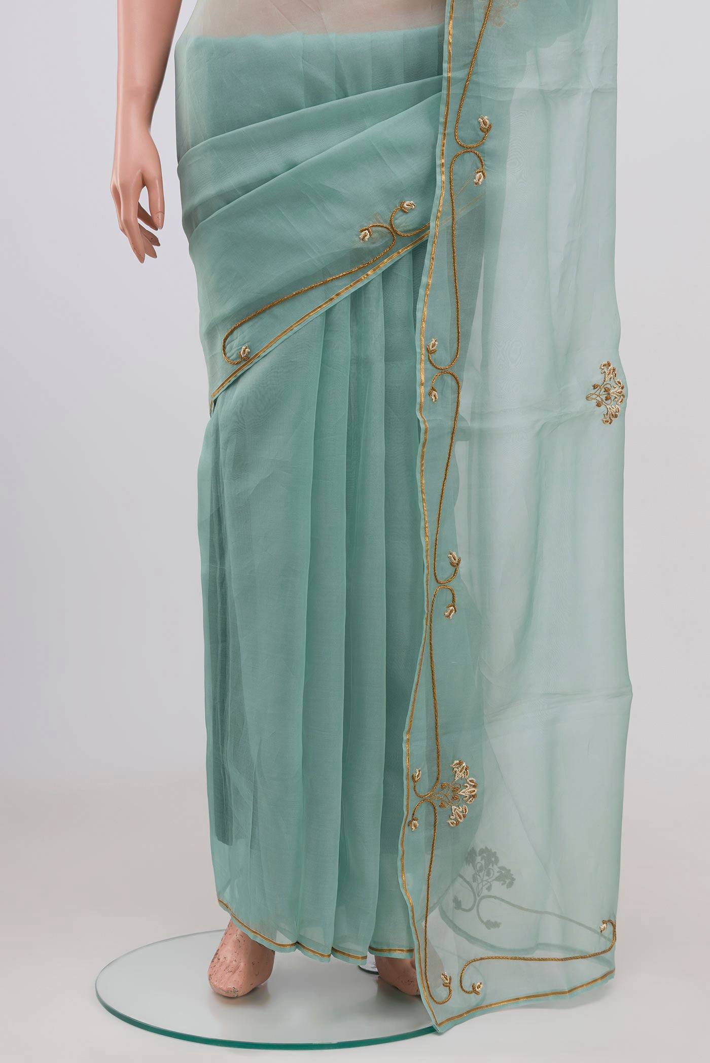Pleats and pallu of Green Organza Silk Saree with Embroidery on the body and Embroidery Border