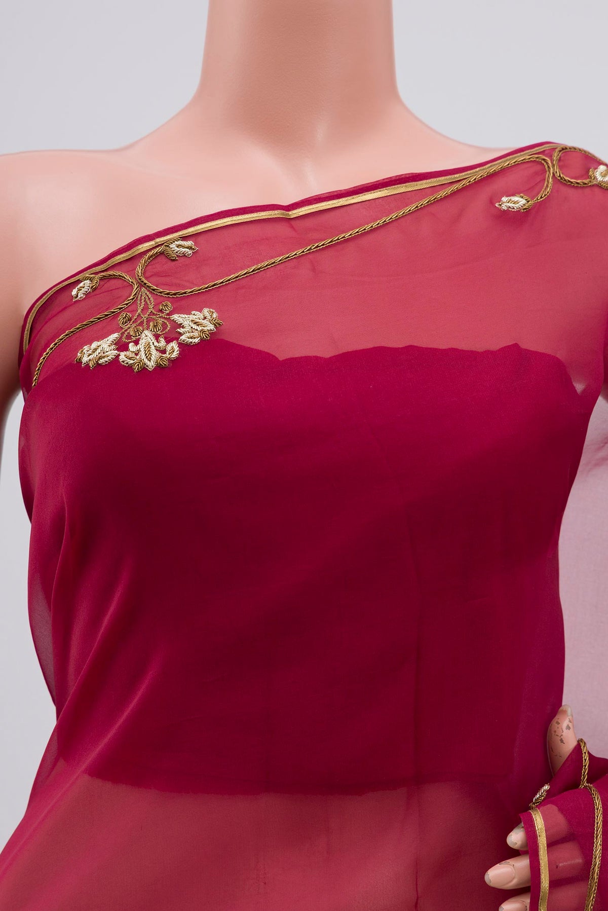 Close up of Maroon Organza Silk Saree with Embroidery on the body and Embroidery Border displaying folds