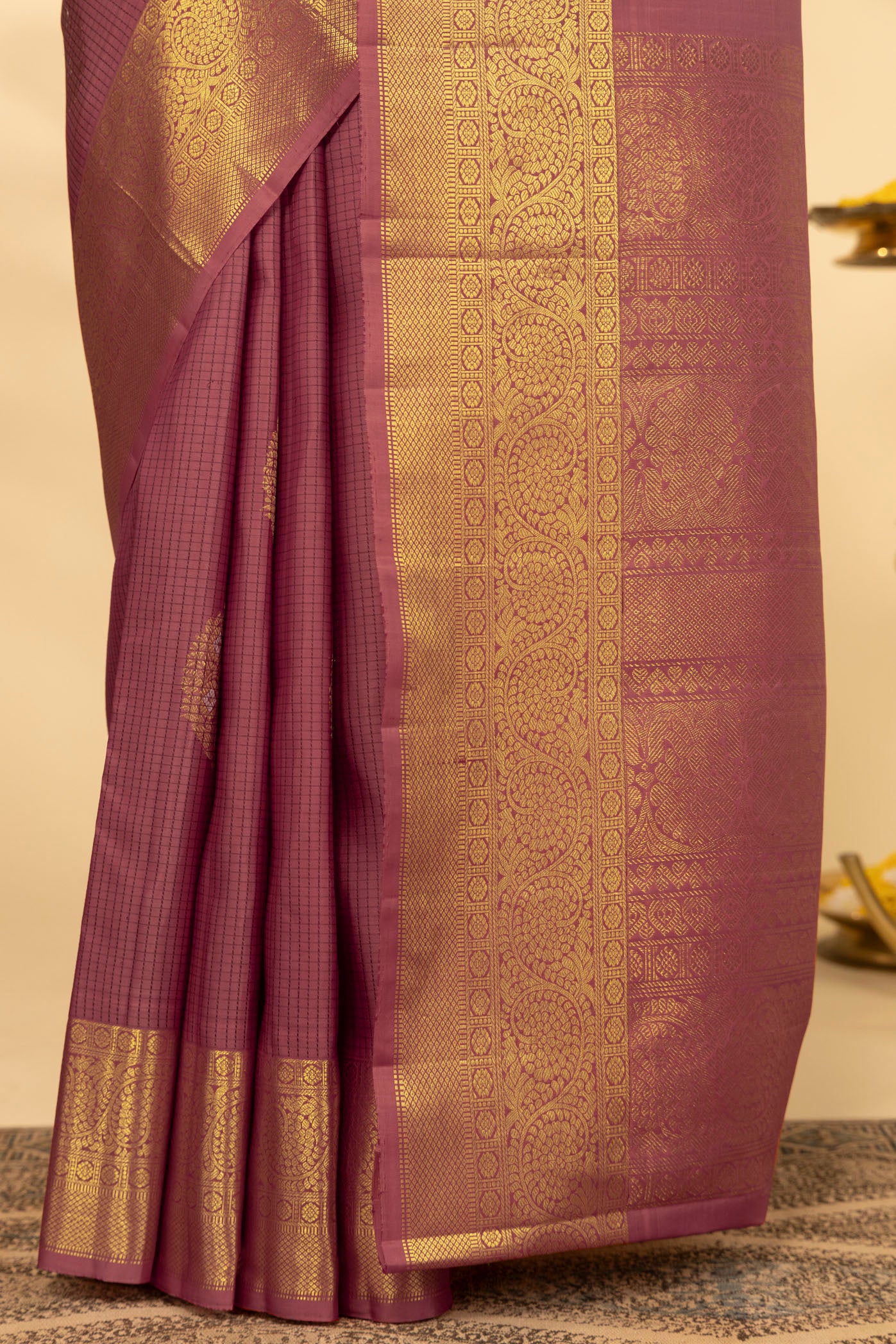 Pleats and pallu of Coral Kanchipuram Silk Saree with Checked design on the body and Zari Border