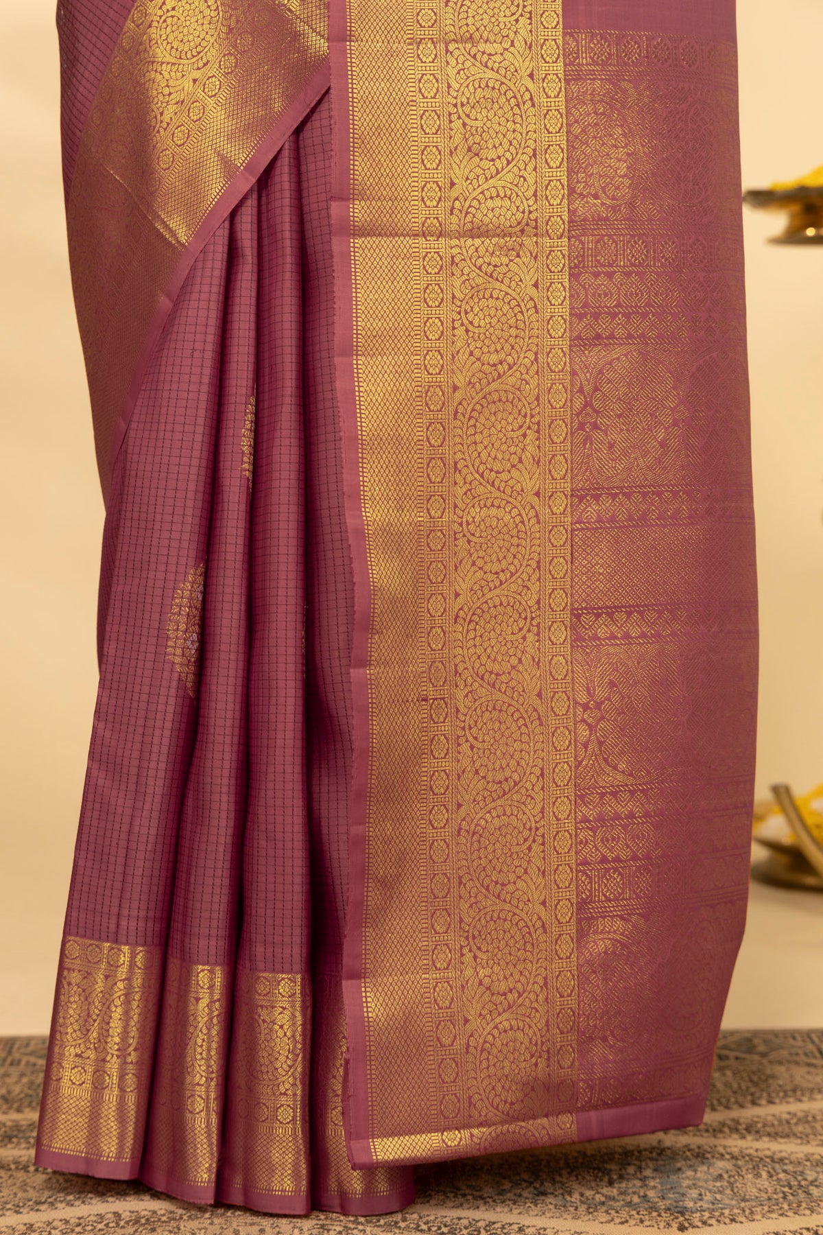 Pleats and pallu of Coral Kanchipuram Silk Saree with Checked design on the body and Zari Border