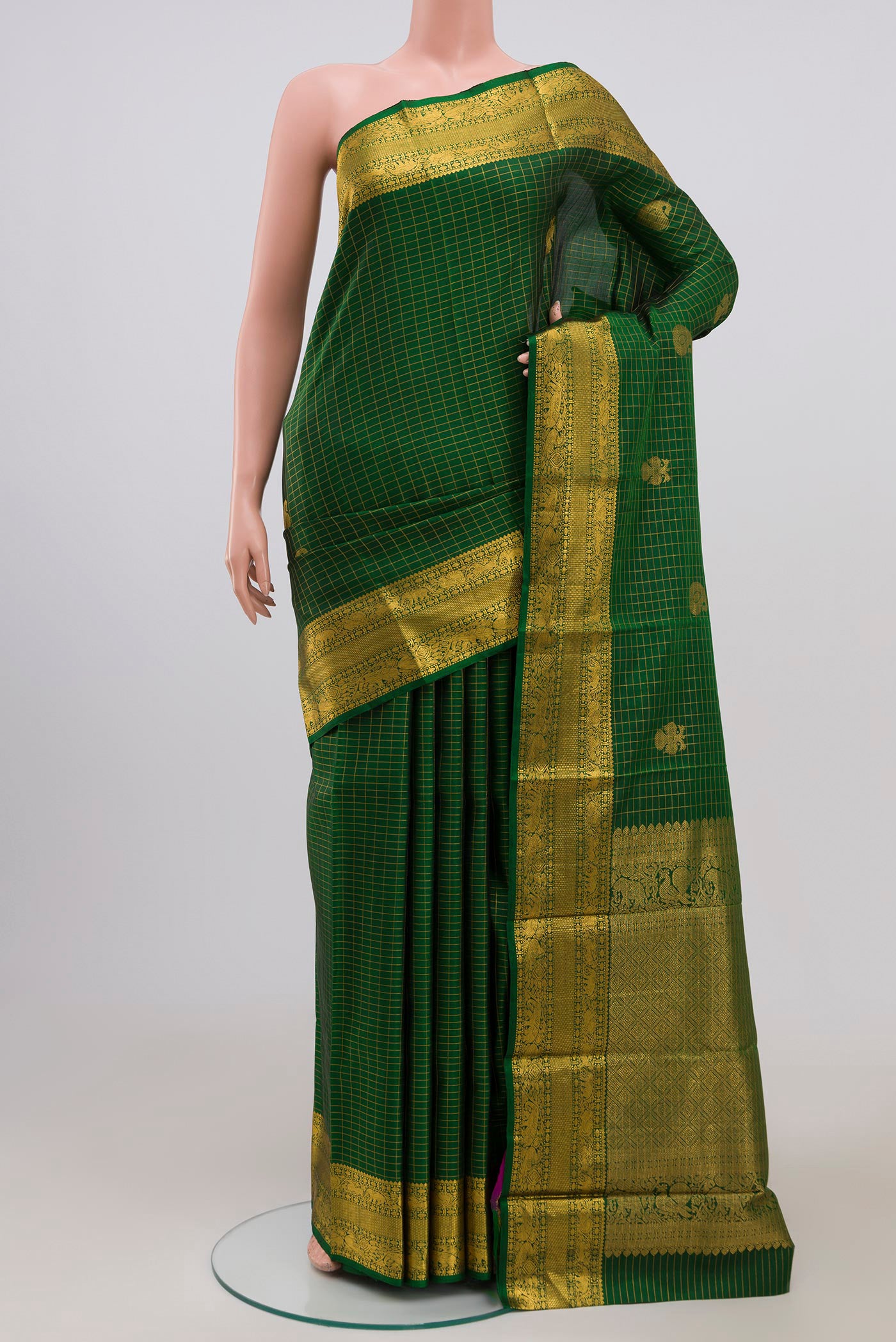 Green Kanjivaram Saree with Checked design on the body and Zari Border.  displayed on a mannequin