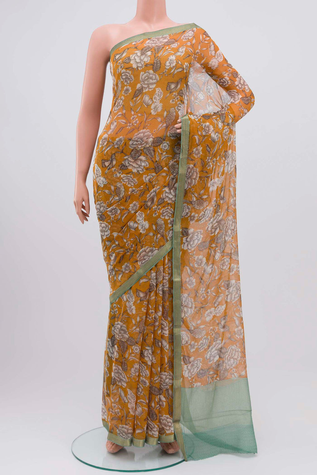 Mustard Mysore Chiffon Saree with Printed design on the body and Zari Border displayed on a mannequin