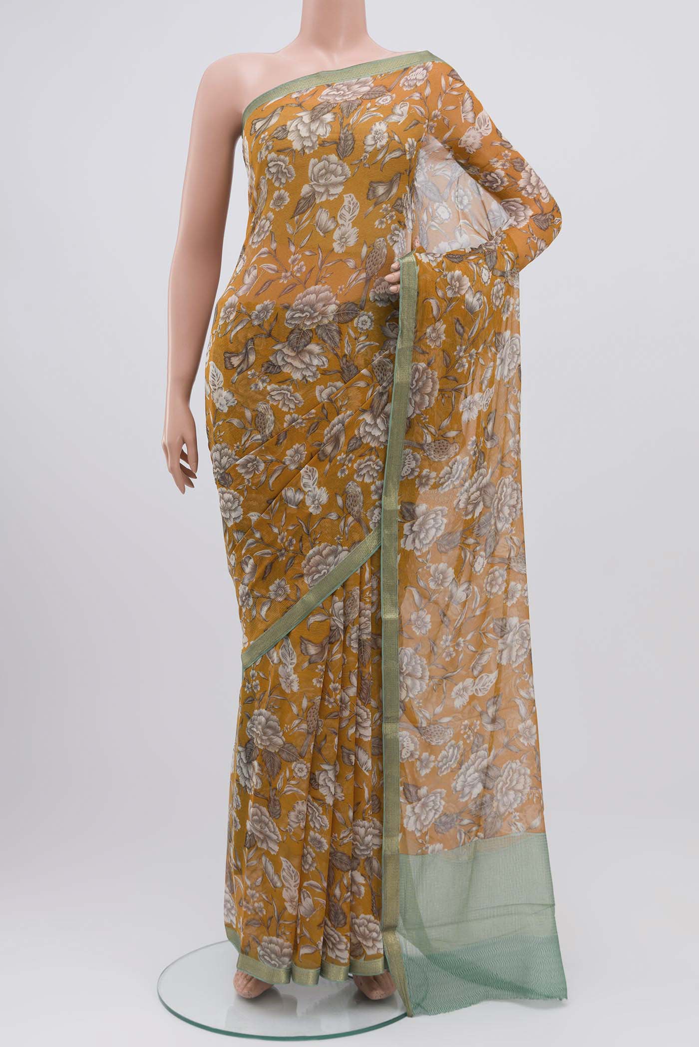 Mustard Mysore Chiffon Saree with Printed design on the body and Zari Border displayed on a mannequin