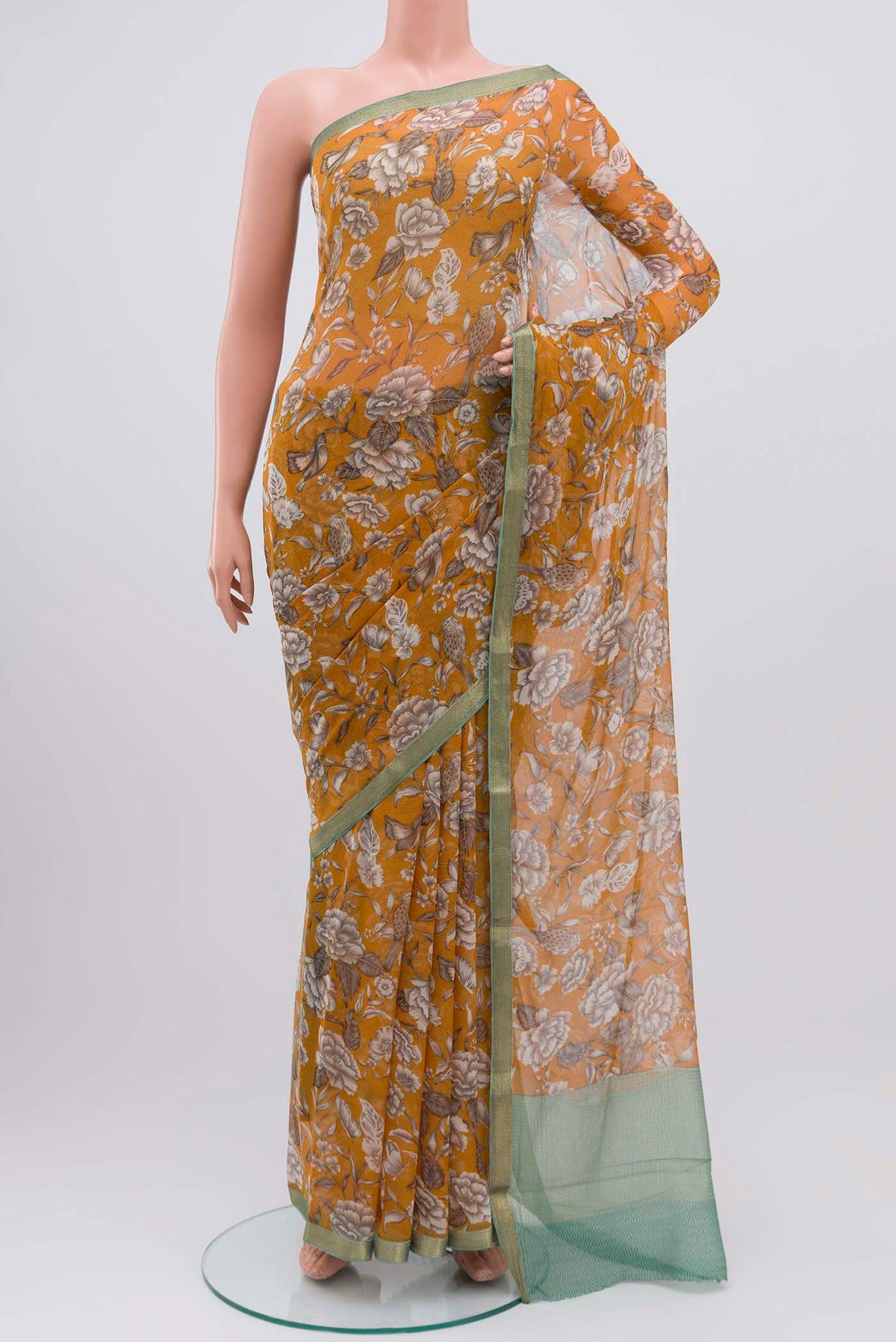 Mustard Mysore Chiffon Saree with Printed design on the body and Zari Border displayed on a mannequin