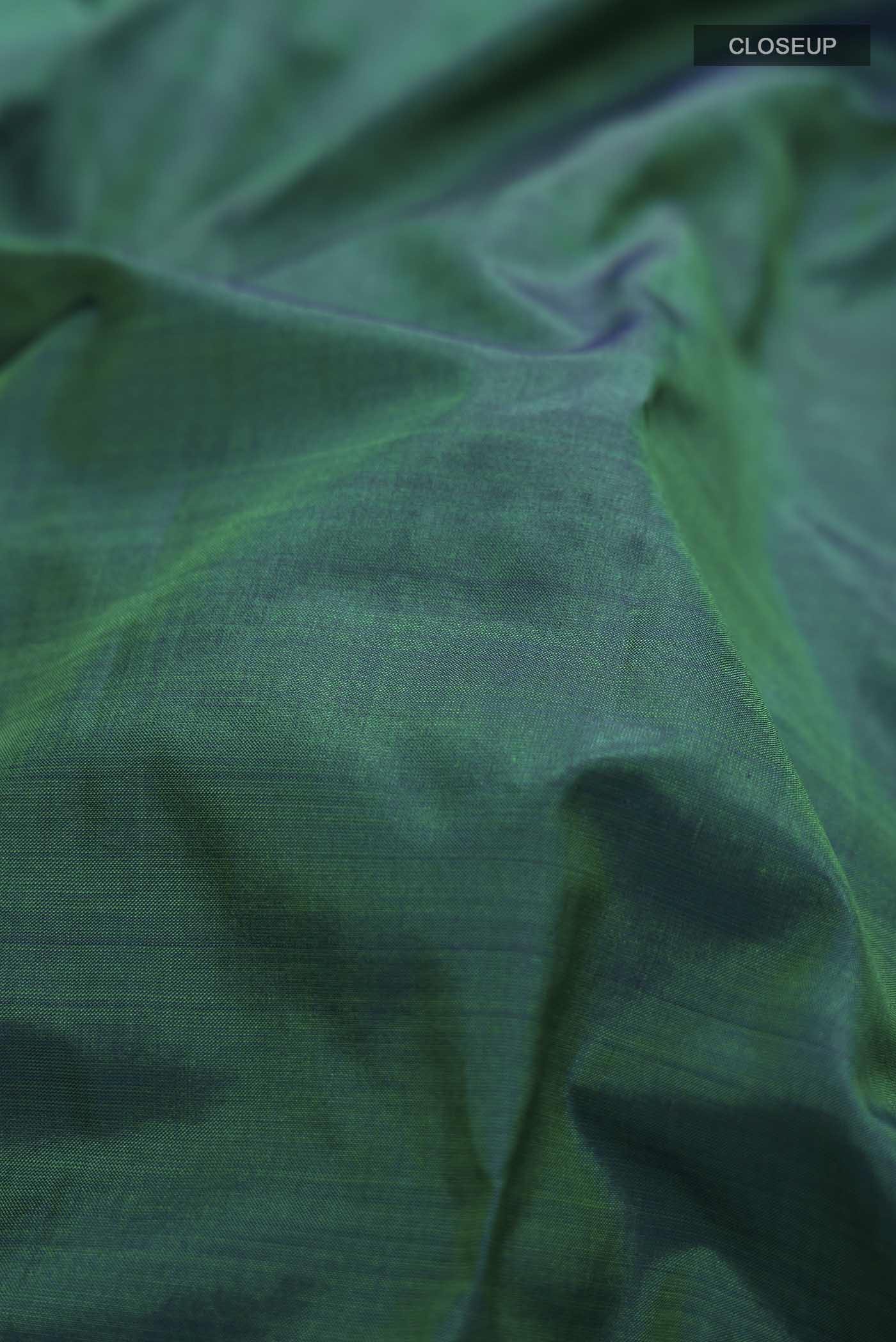 Close up of Green Kanchipuram Silk Nine Yards Saree with Plain Body and Zari Border displaying folds