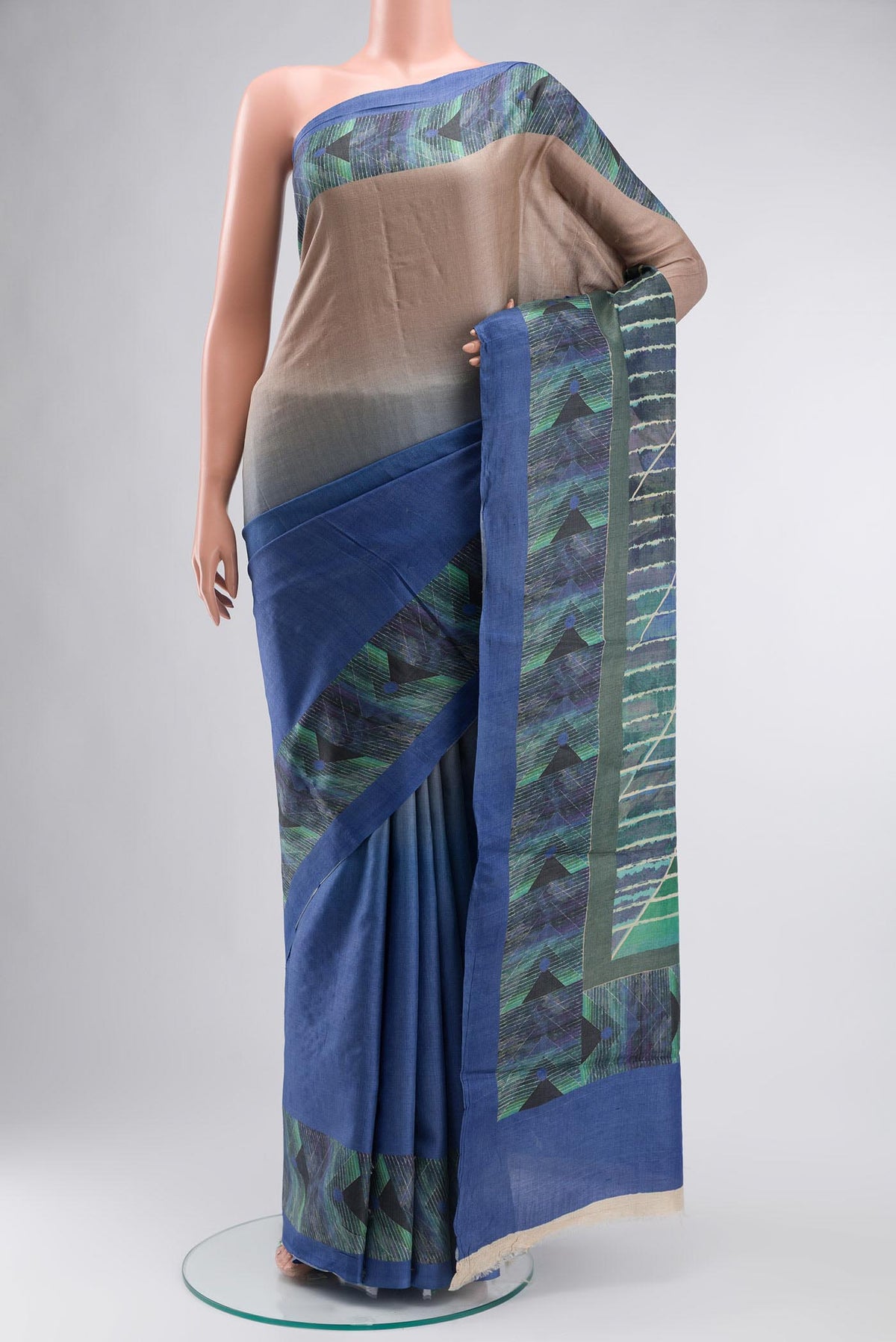 Blue Tussar Silk Saree With Printed design on the body and Plain Border displayed on a mannequin