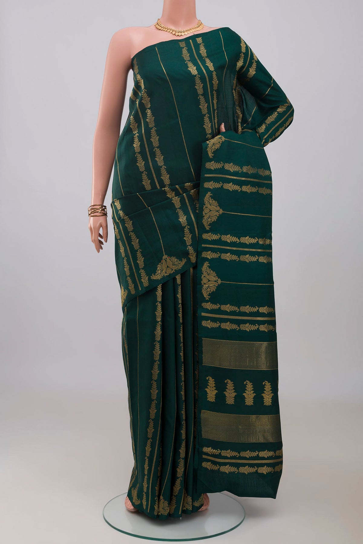 Pure Silk Pure Zari Bottle Green Kanjivaram Saree with Stripes on the body and Without Border.  displayed on a mannequin