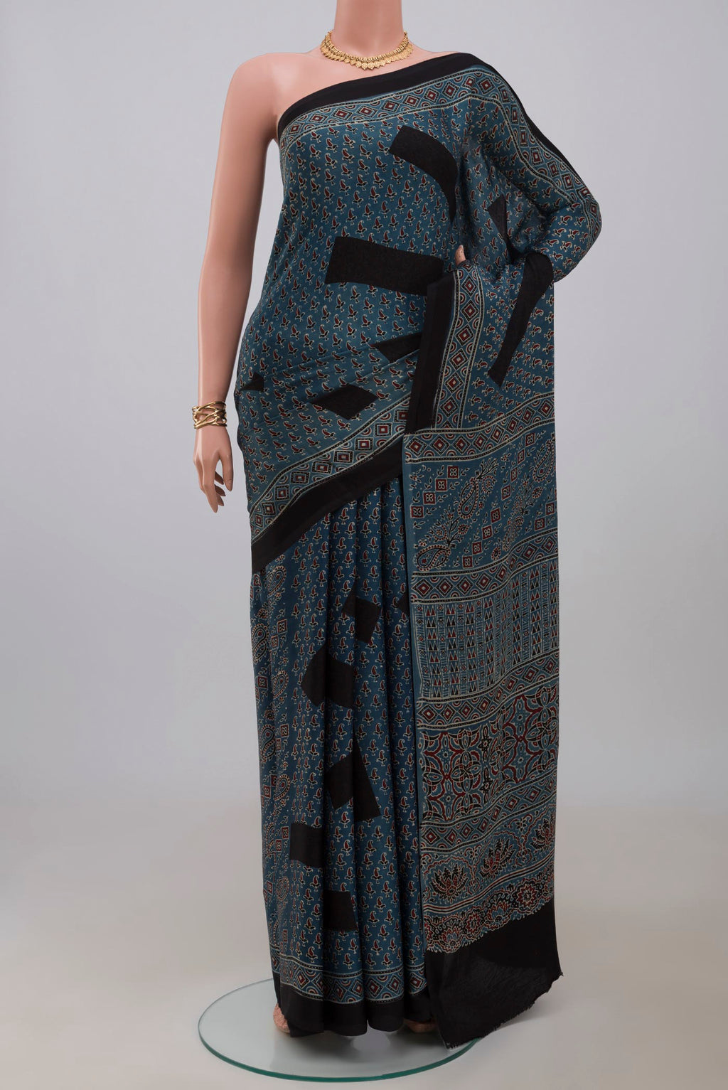 Blue Blended Satin Silk Saree with Ajrakh Print on the body and Printed Border.  displayed on a mannequin