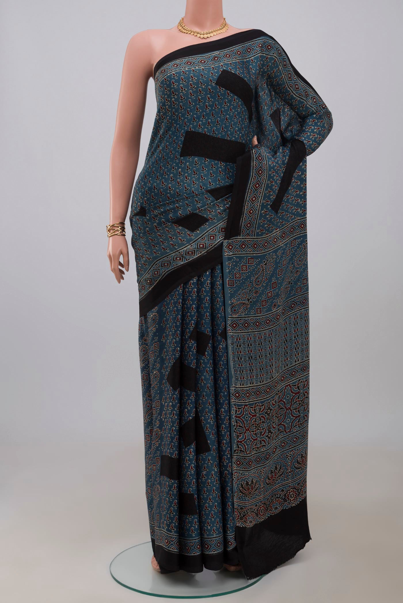Blue Blended Satin Silk Saree with Ajrakh Print on the body and Printed Border.  displayed on a mannequin