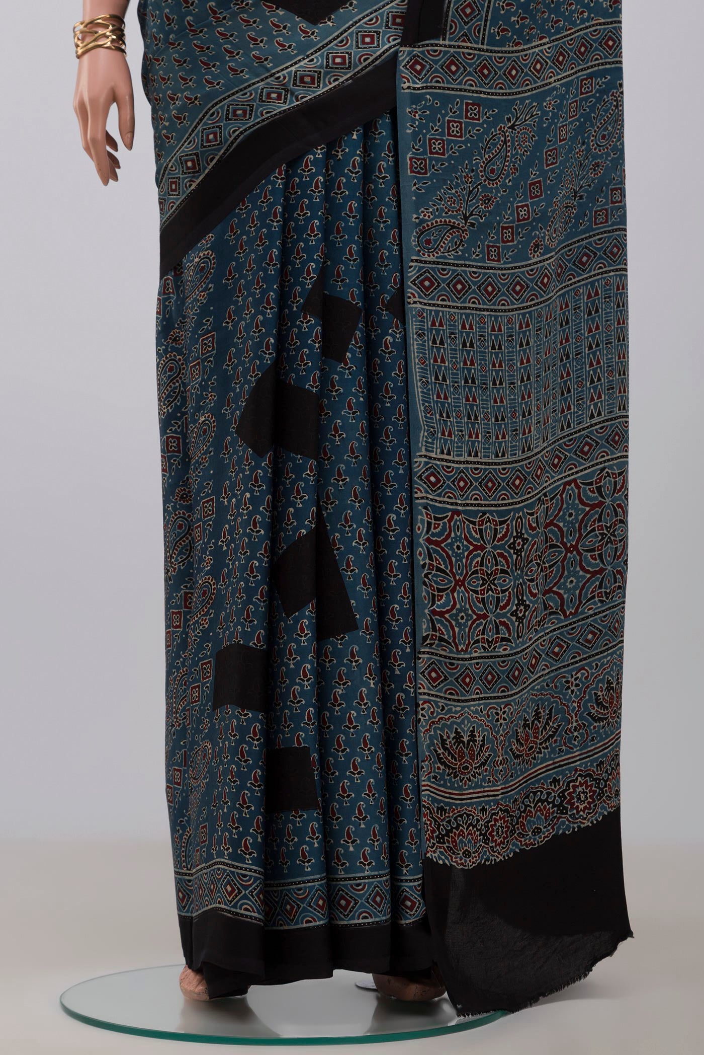 Pleats and pallu of Blue Blended Satin Silk Saree with Ajrakh Print on the body and Printed Border. 