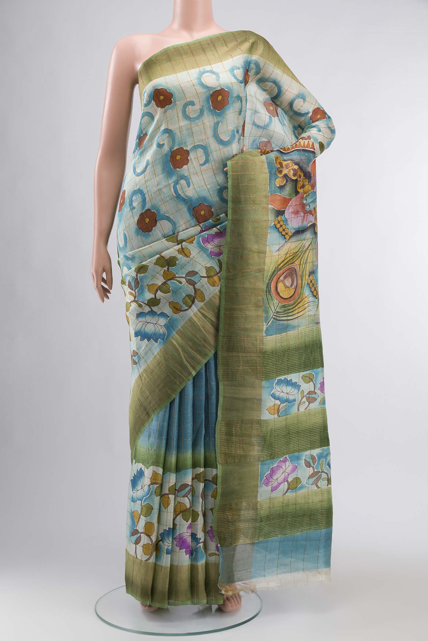 Blue Tussar Silk Saree with Printed design on the body and Zari Border displayed on a mannequin