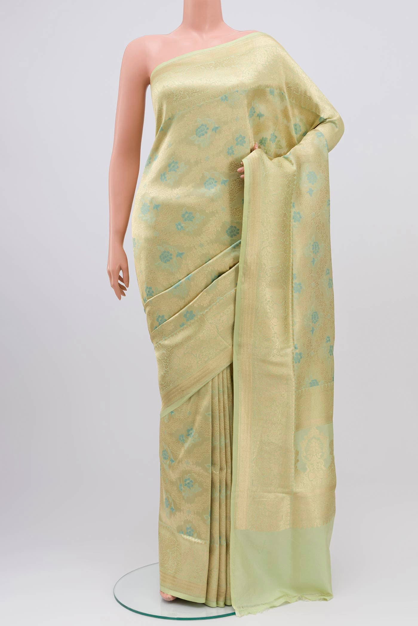 Beige Banarasi Silk Saree with Zari And Thread Butta on the body and Zari Border displayed on a mannequin