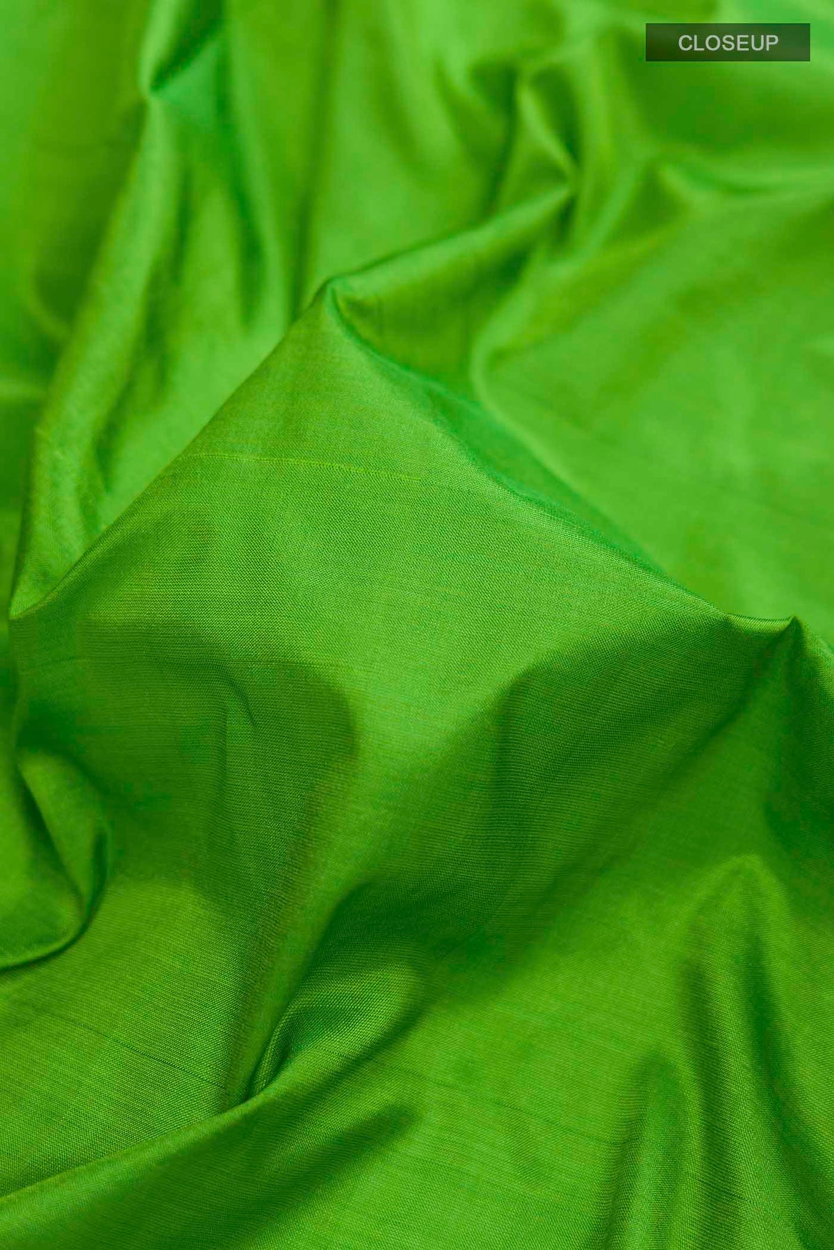 Close up of Green Kanchipuram Silk Nine Yards Saree with Plain Body and Zari Border displaying folds