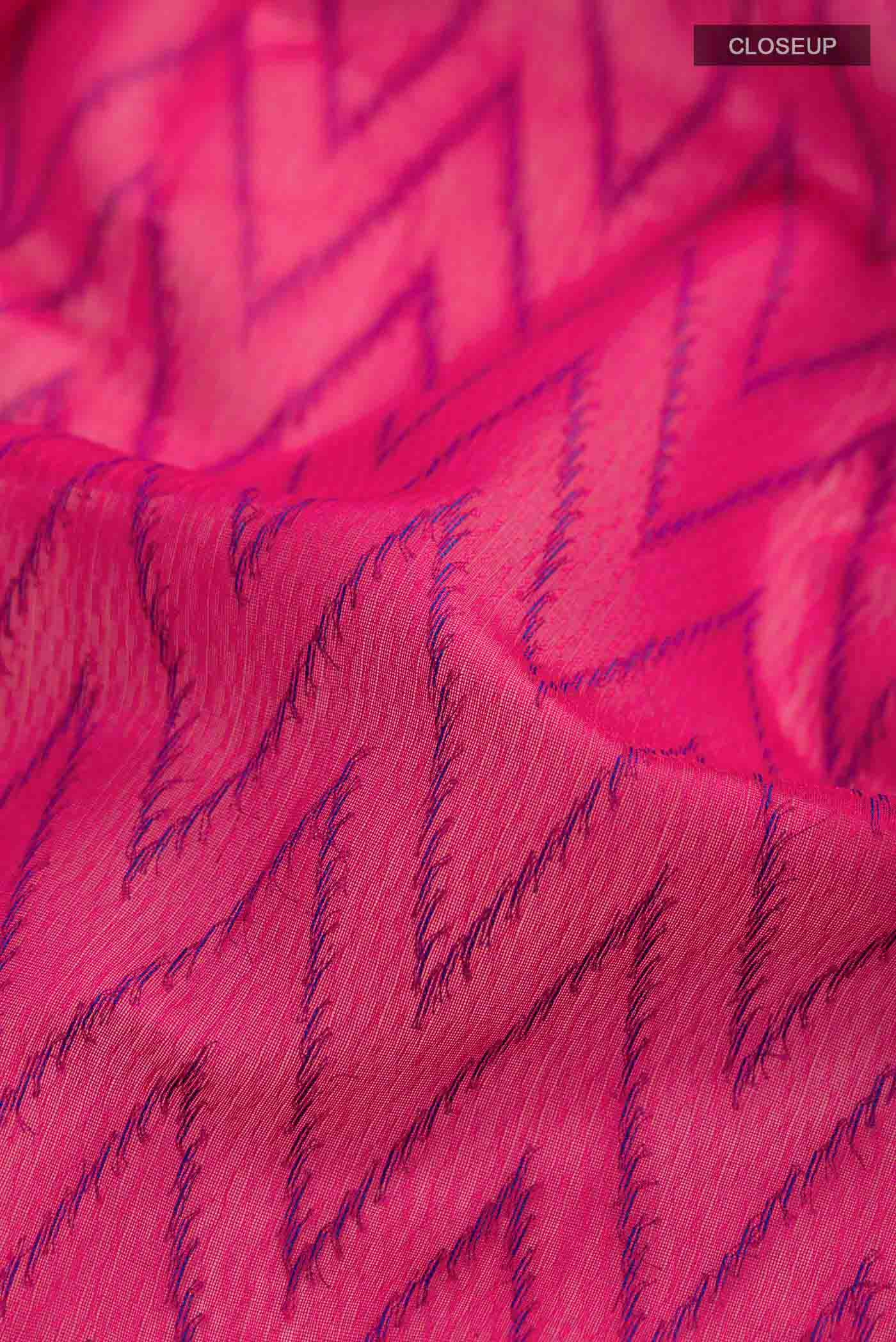 Close up of Pink Silk Cotton SareeZig Zag design on the body and Zari Border displaying folds
