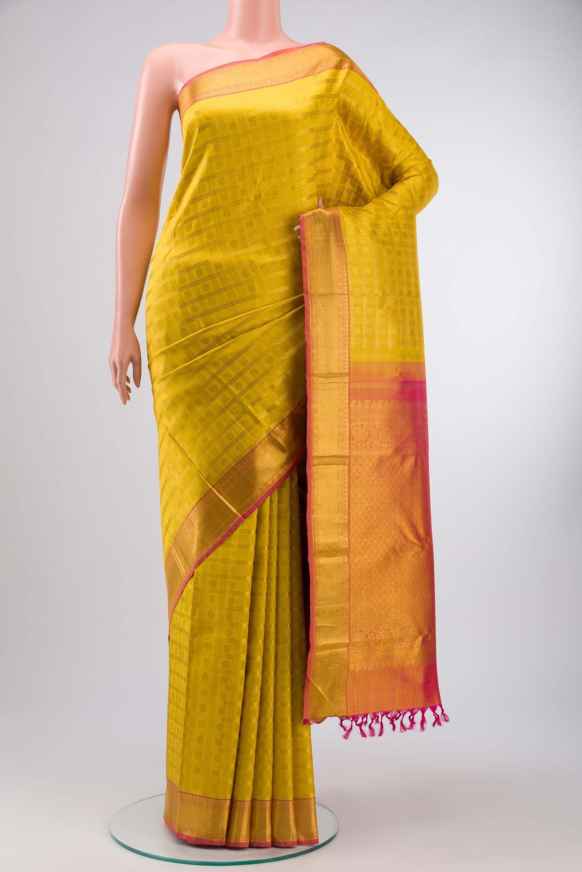 Yellow Kanchipuram Silk Saree with Zari Brocade on the body and Zari Border displayed on a mannequin