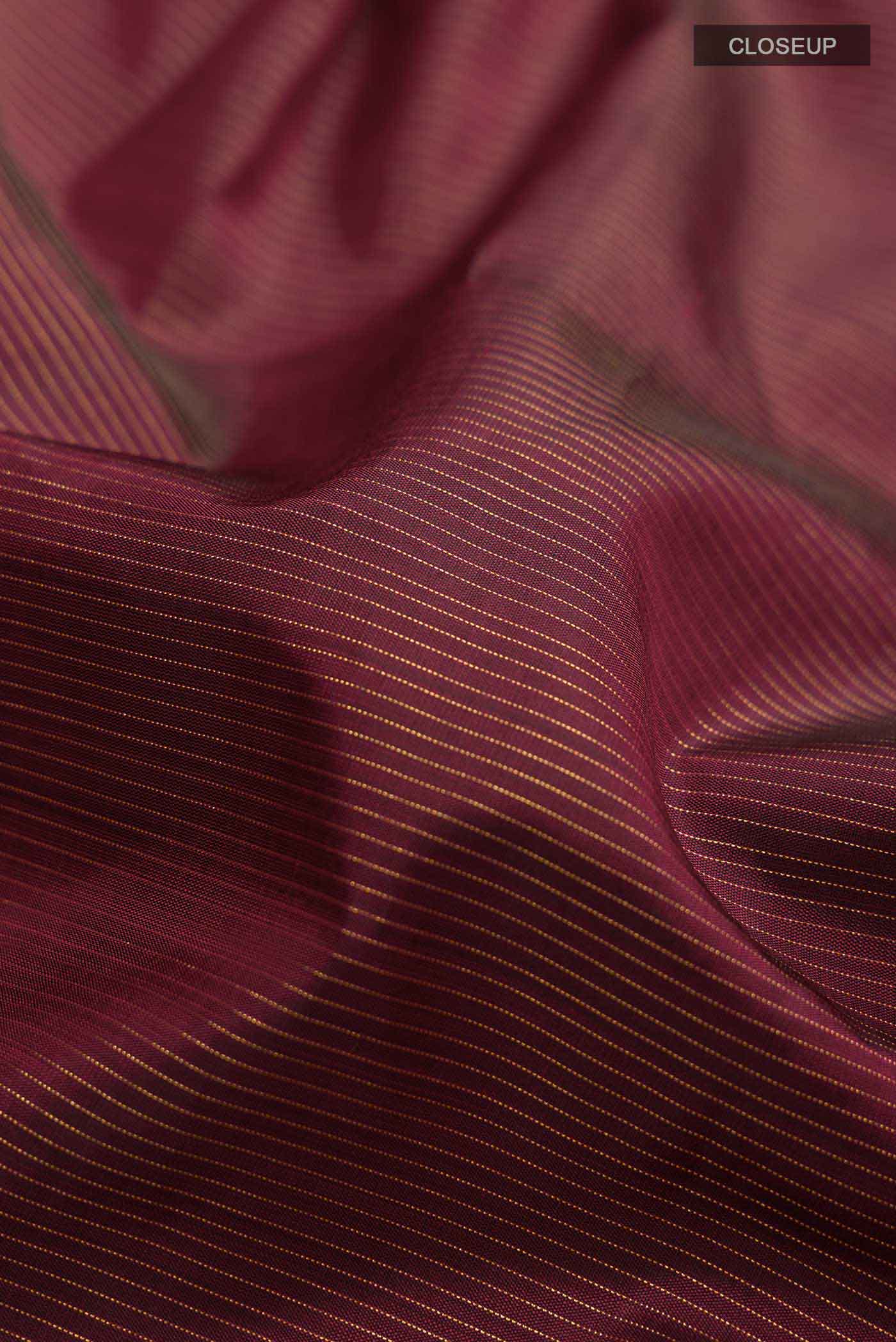 Close up of Pure Silk Pure Zari Maroon Kanchipuram Nine Yards Saree with Stripes on the body and Zari Border displaying folds