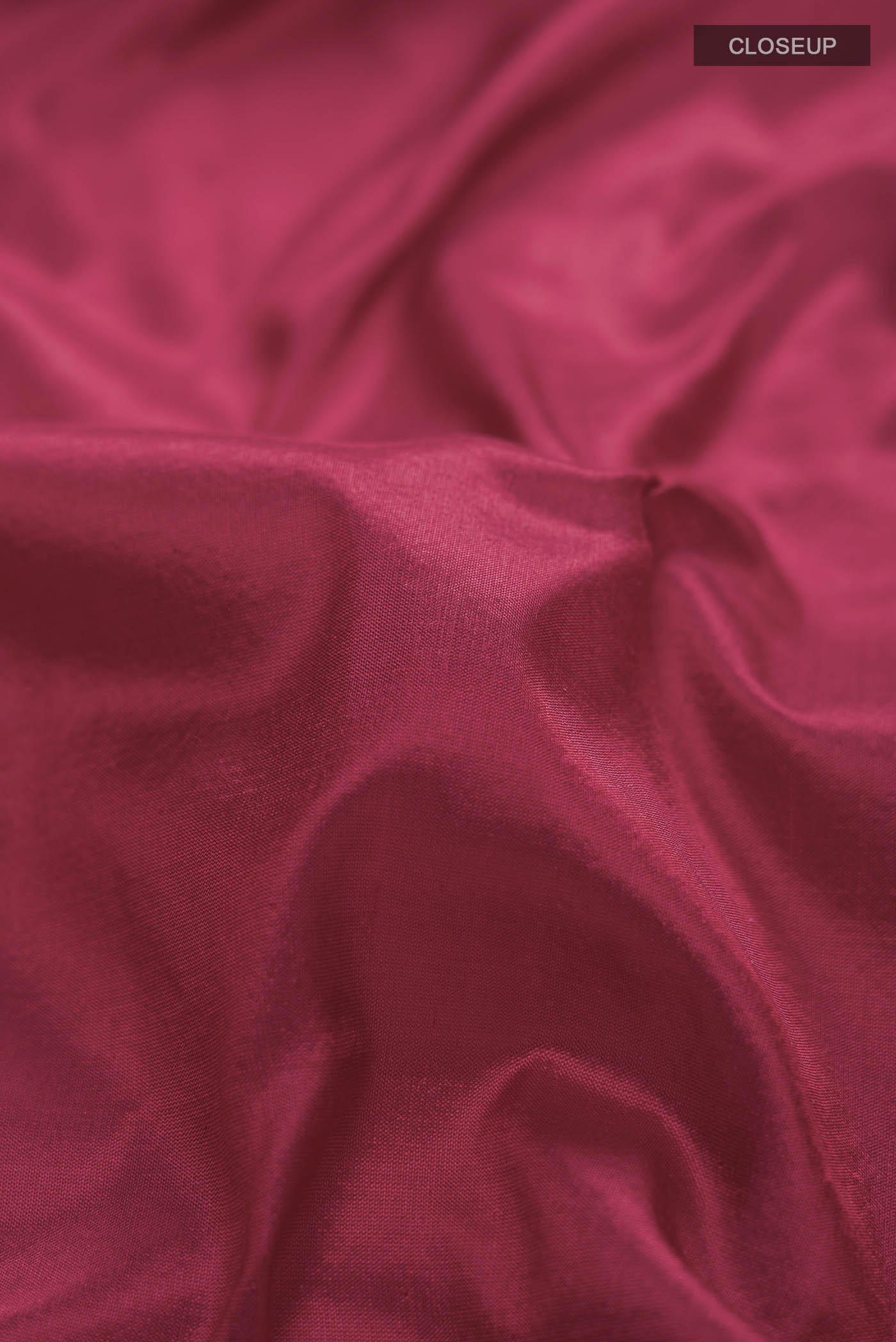 Close up of Maroon Kanchipuram Silk Nine Yards Saree with Plain Body and Zari Border displaying folds