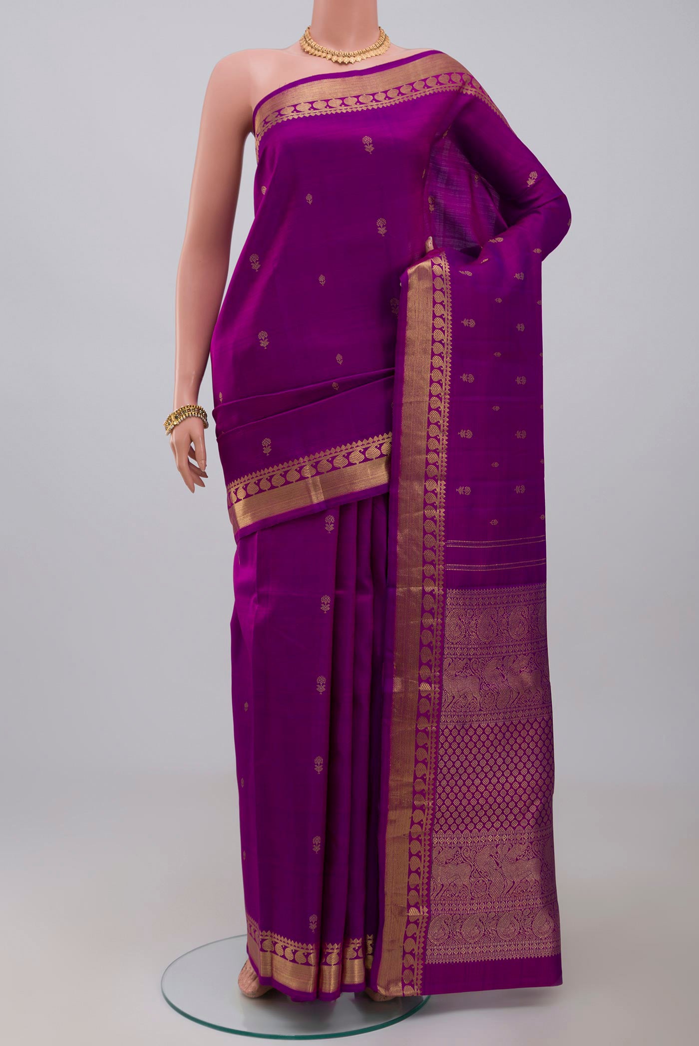 Pure Silk Pure Zari Purple Kanchipuram Saree with Zari Butta on the body and Zari Border.  displayed on a mannequin