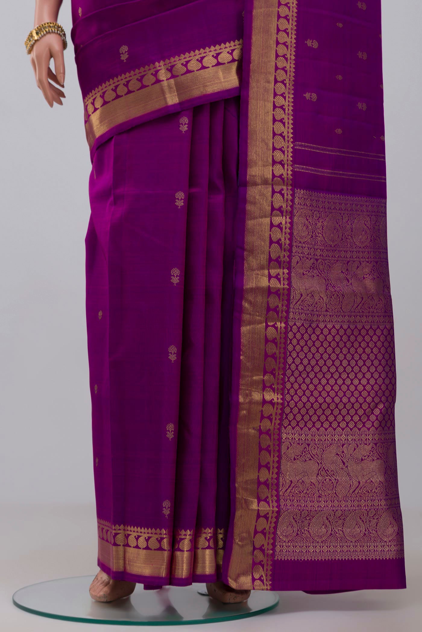 Pleats and pallu of Pure Silk Pure Zari Purple Kanchipuram Saree with Zari Butta on the body and Zari Border. 
