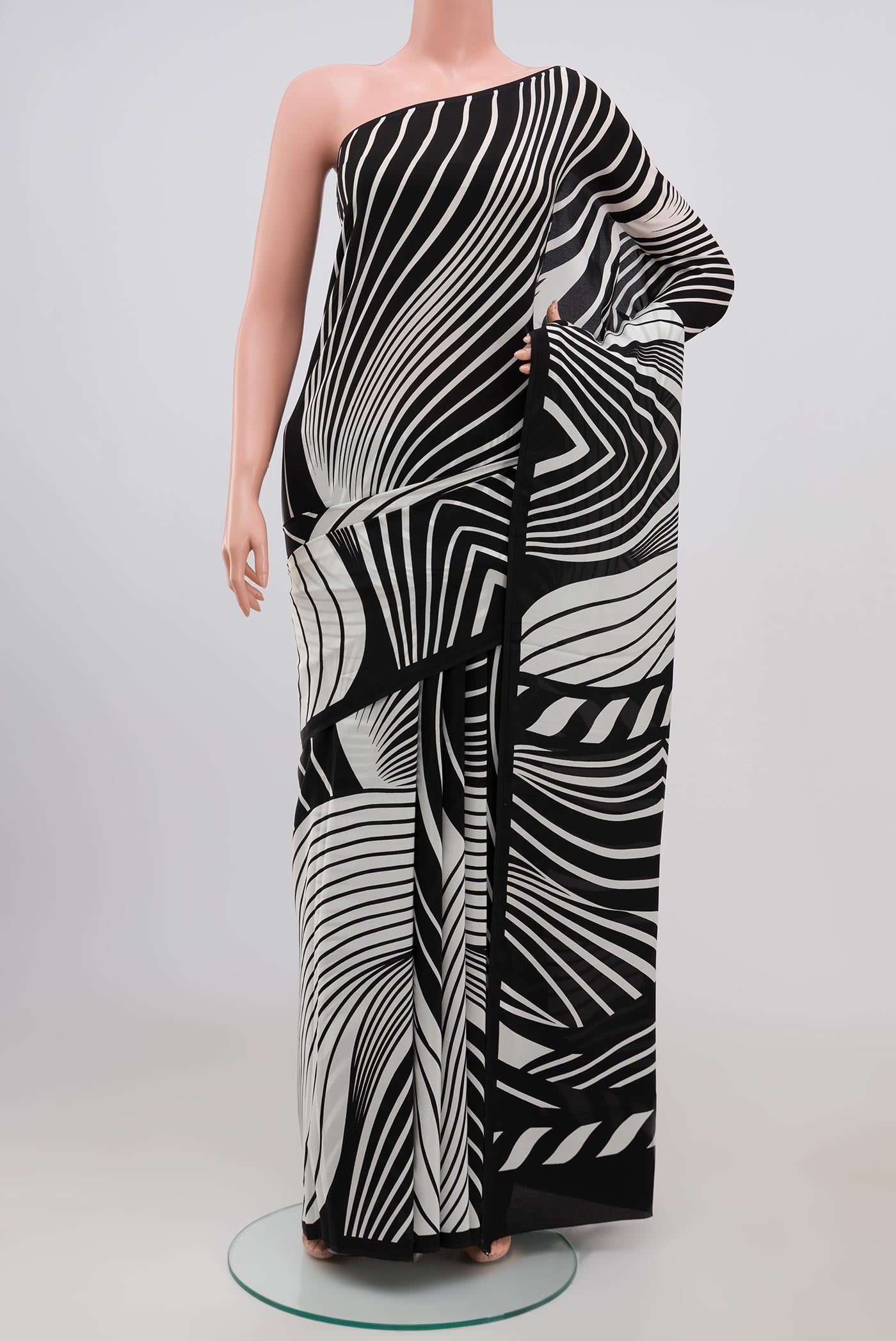 Black Crepe Saree with Printed design on the body and Plain Border.  displayed on a mannequin