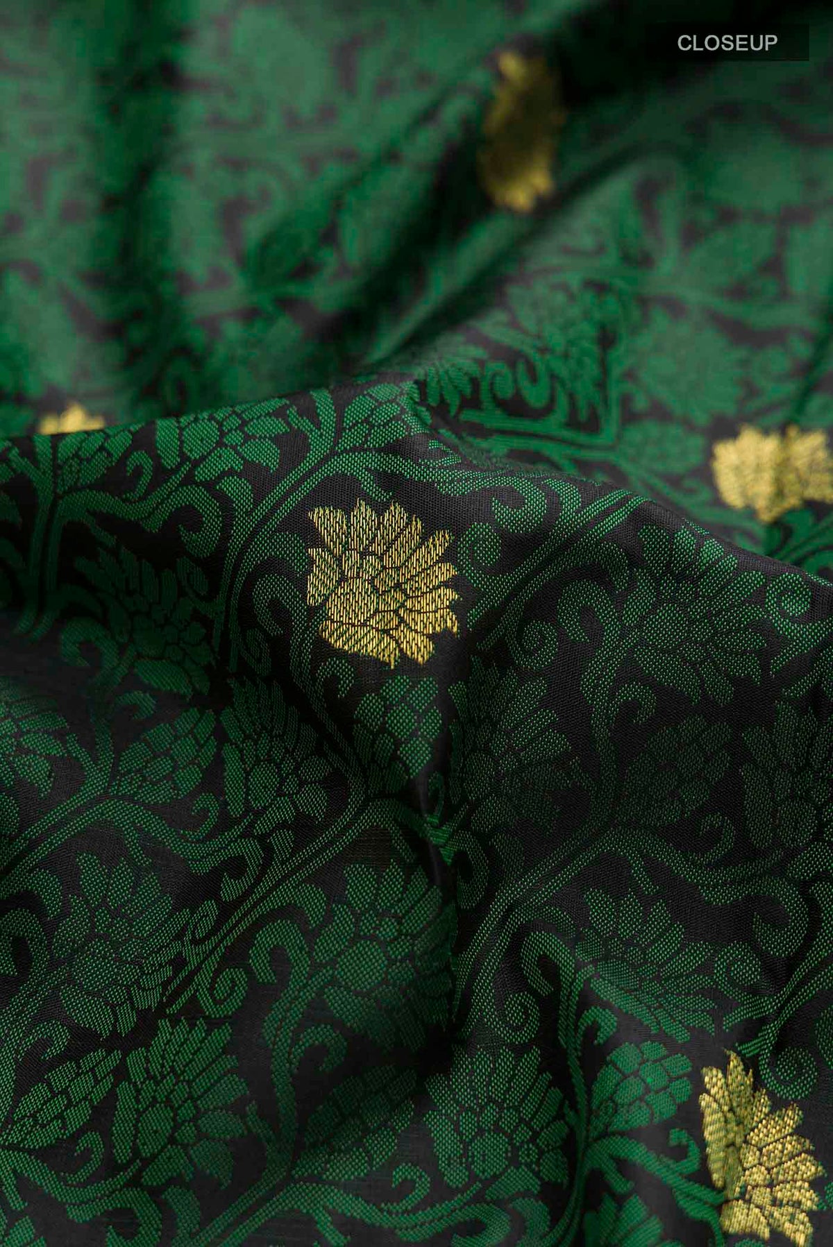 Close up of Black Kanchipuram Silk Saree with Jacquard design on the body and Ganga Jamuna Border displaying folds