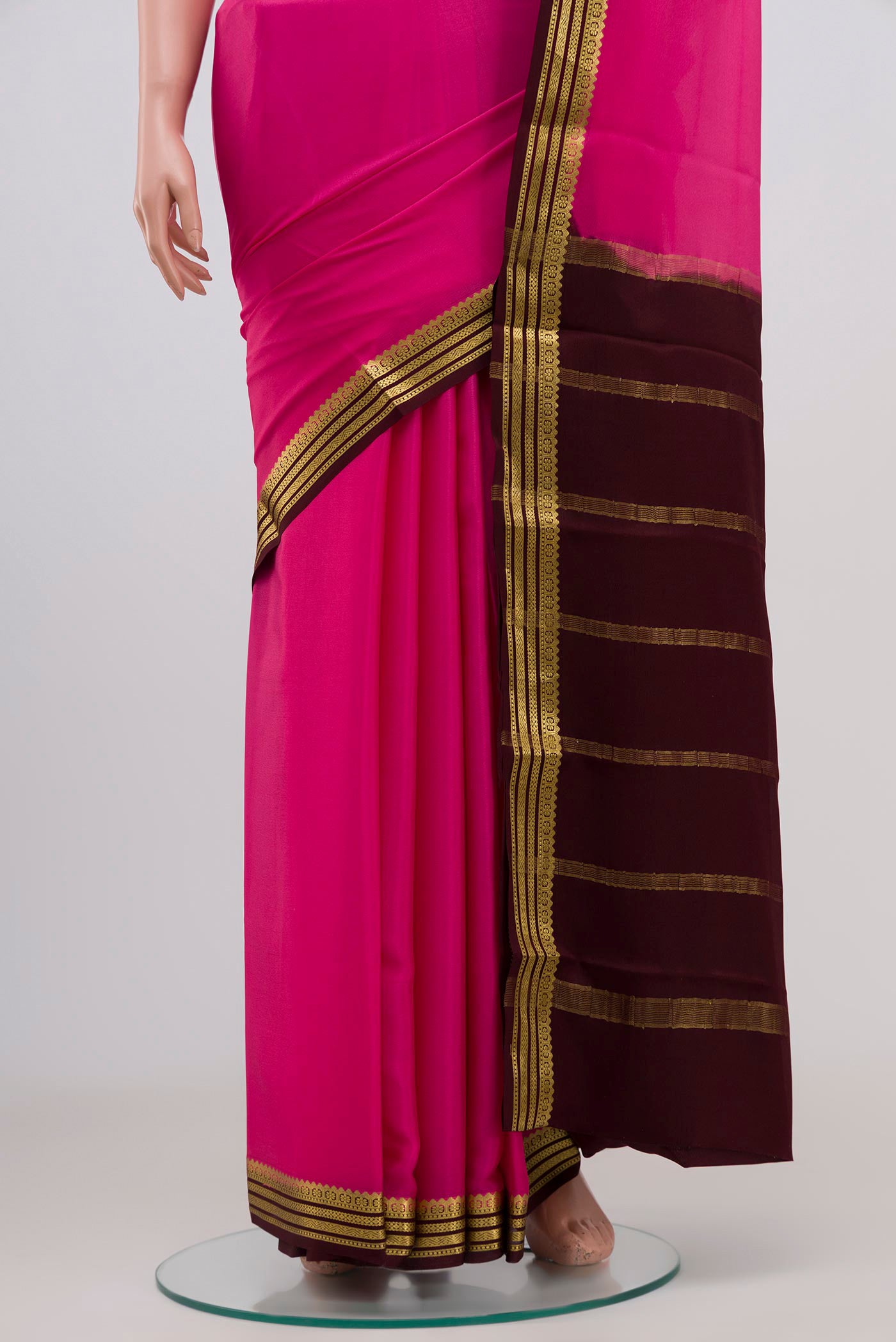 Pleats and pallu of Pink Crepe Saree with Plain Body and Zari Border. 