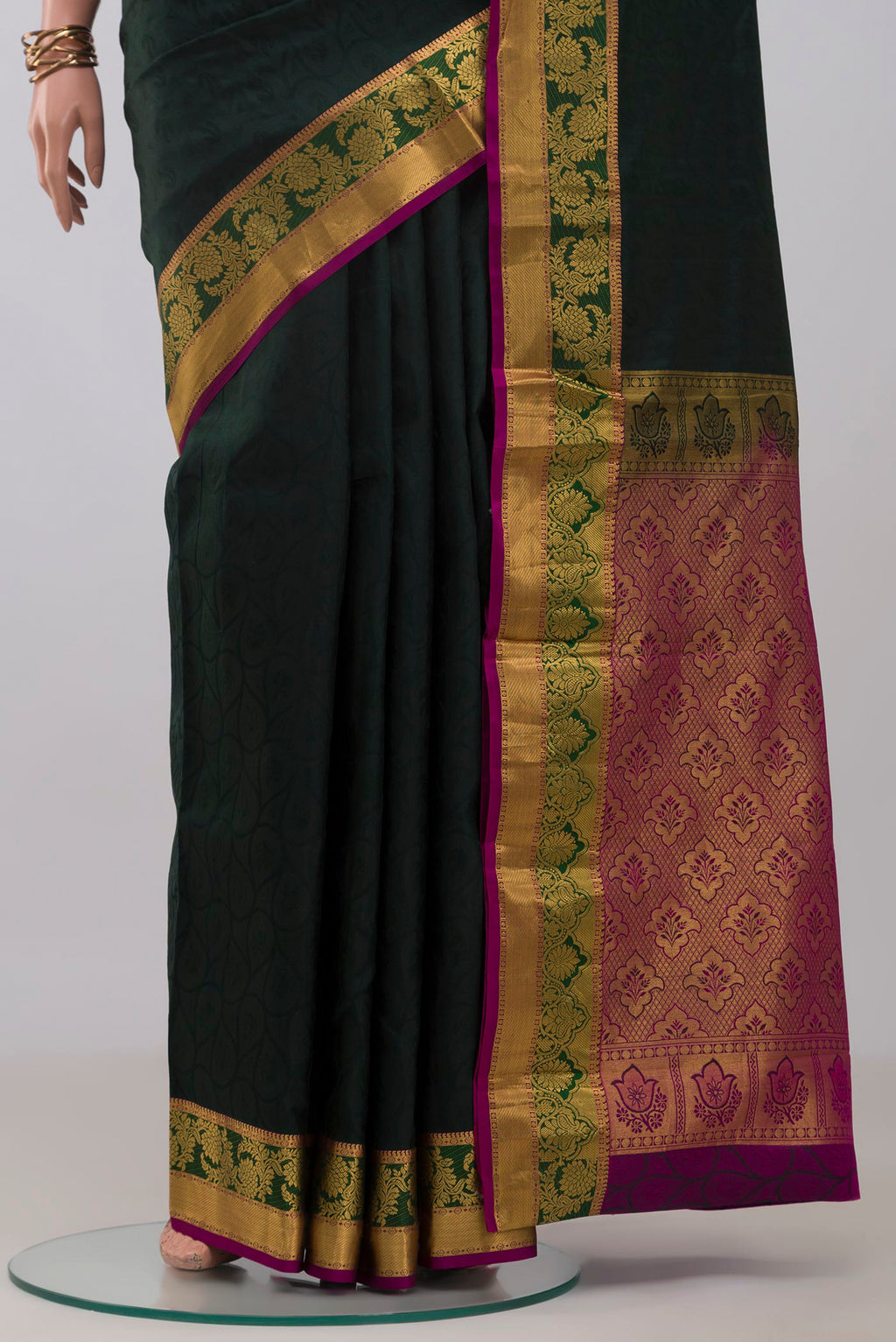 Pleats and pallu of Bottle Green Kanjivaram Silk Saree with Jacquard design on the body and Zari Border. 