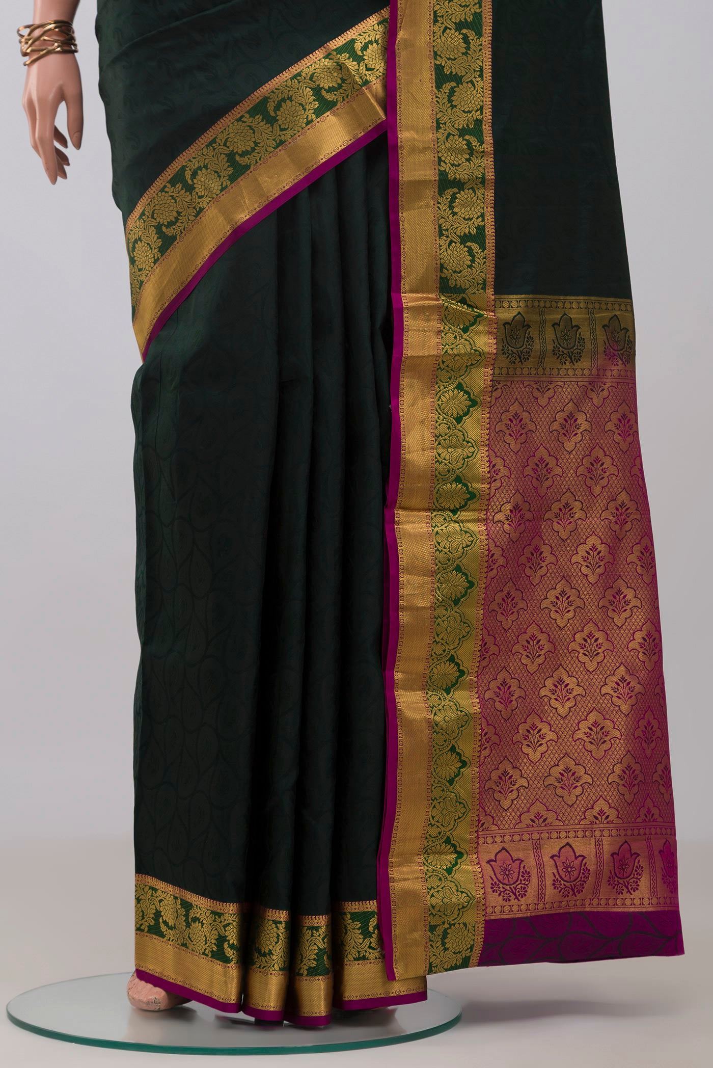 Pleats and pallu of Bottle Green Kanjivaram Silk Saree with Jacquard design on the body and Zari Border. 
