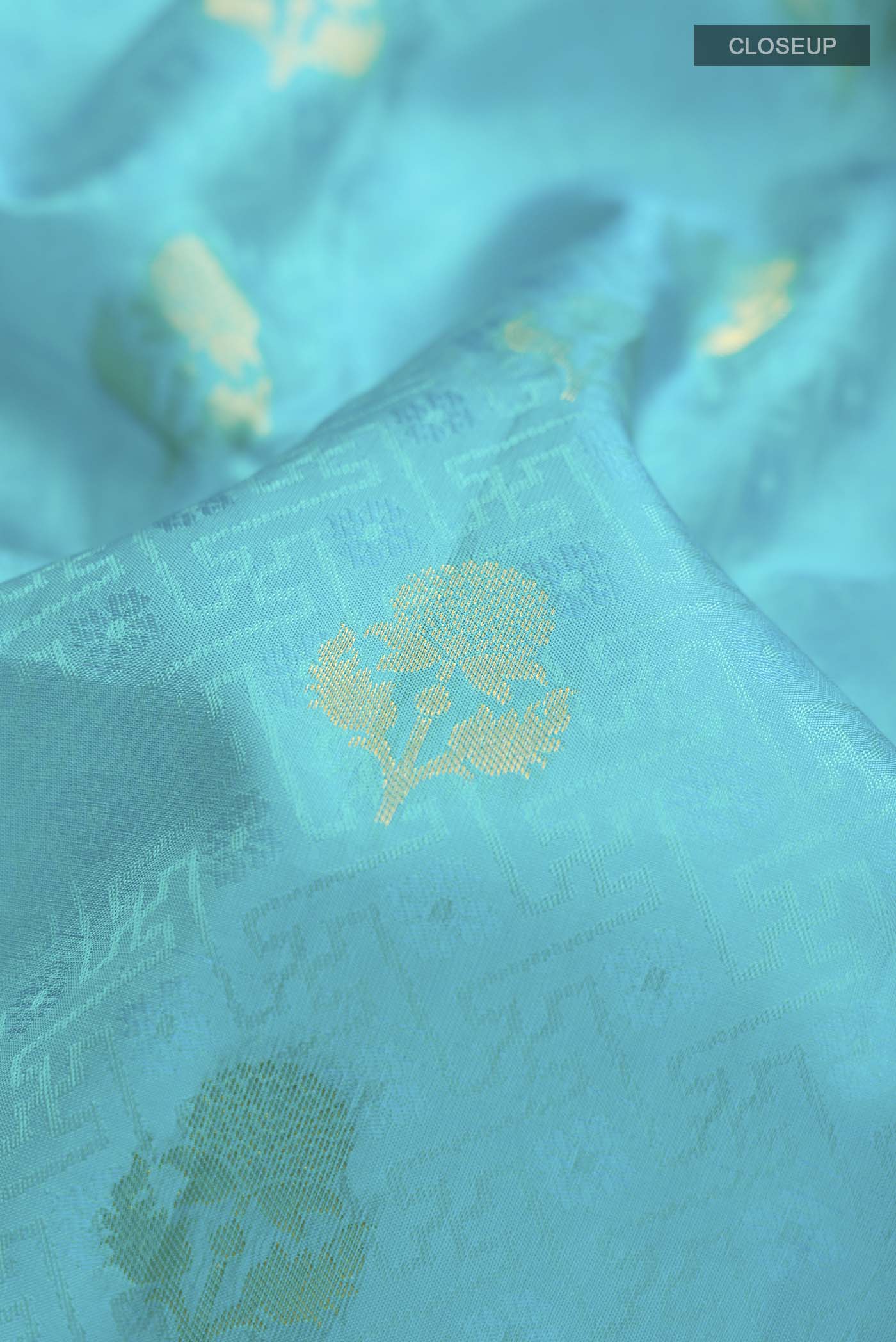 Close up of Blue Kanchipuram Silk Saree with Jacquard With Zari Butta on the body and Zari Border displaying folds