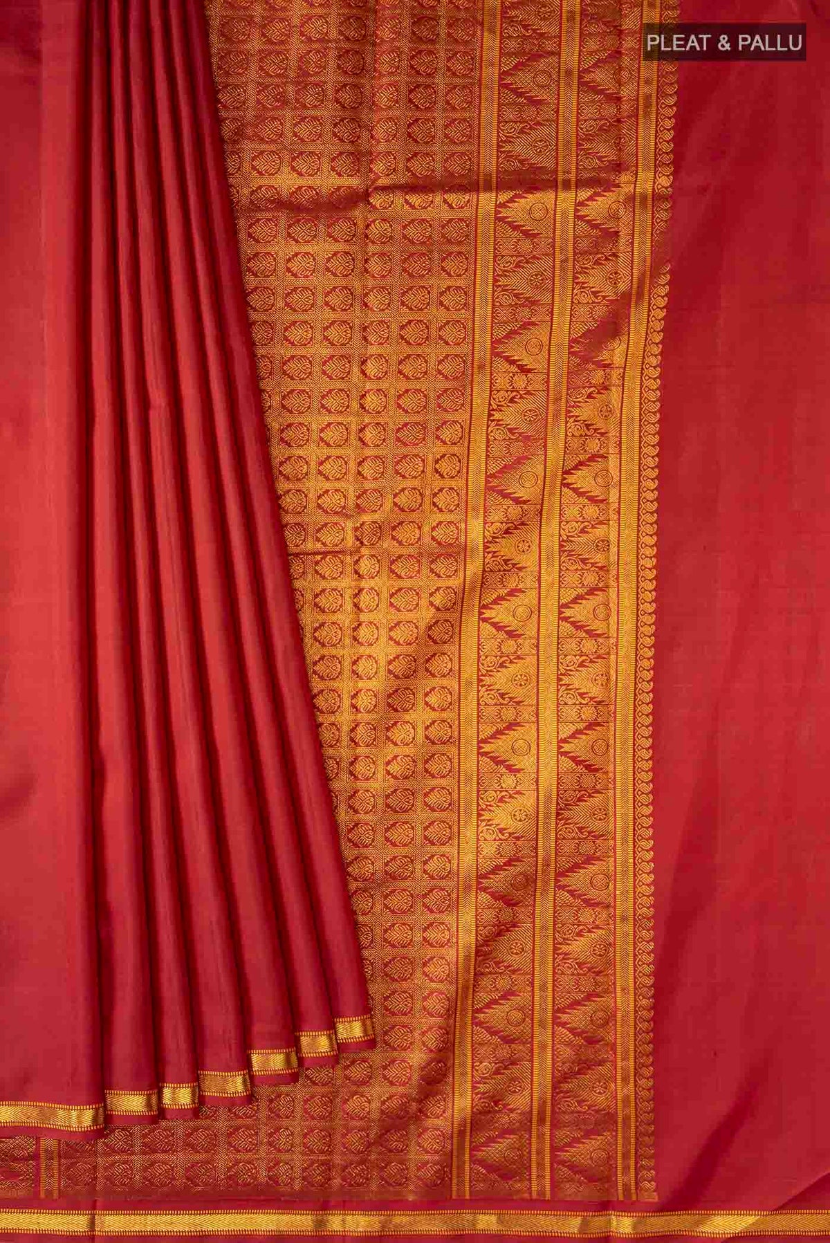 Pleats and pallu of Maroon Kanchipuram Silk Saree with Zari Butta on the body and Zari Border