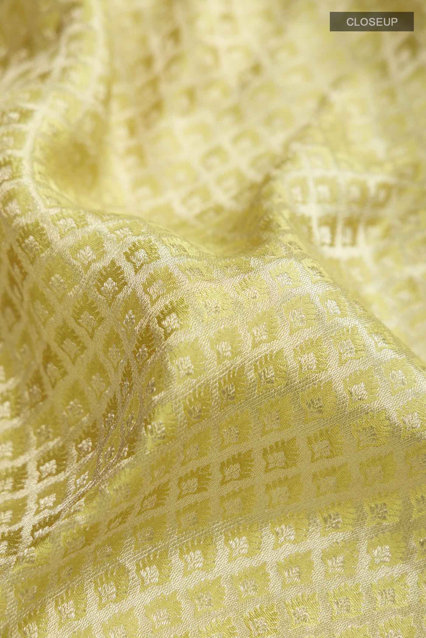 Close up of Yellow Mysore Crepe Saree with Zari Brocade on the body and Zari Border displaying folds