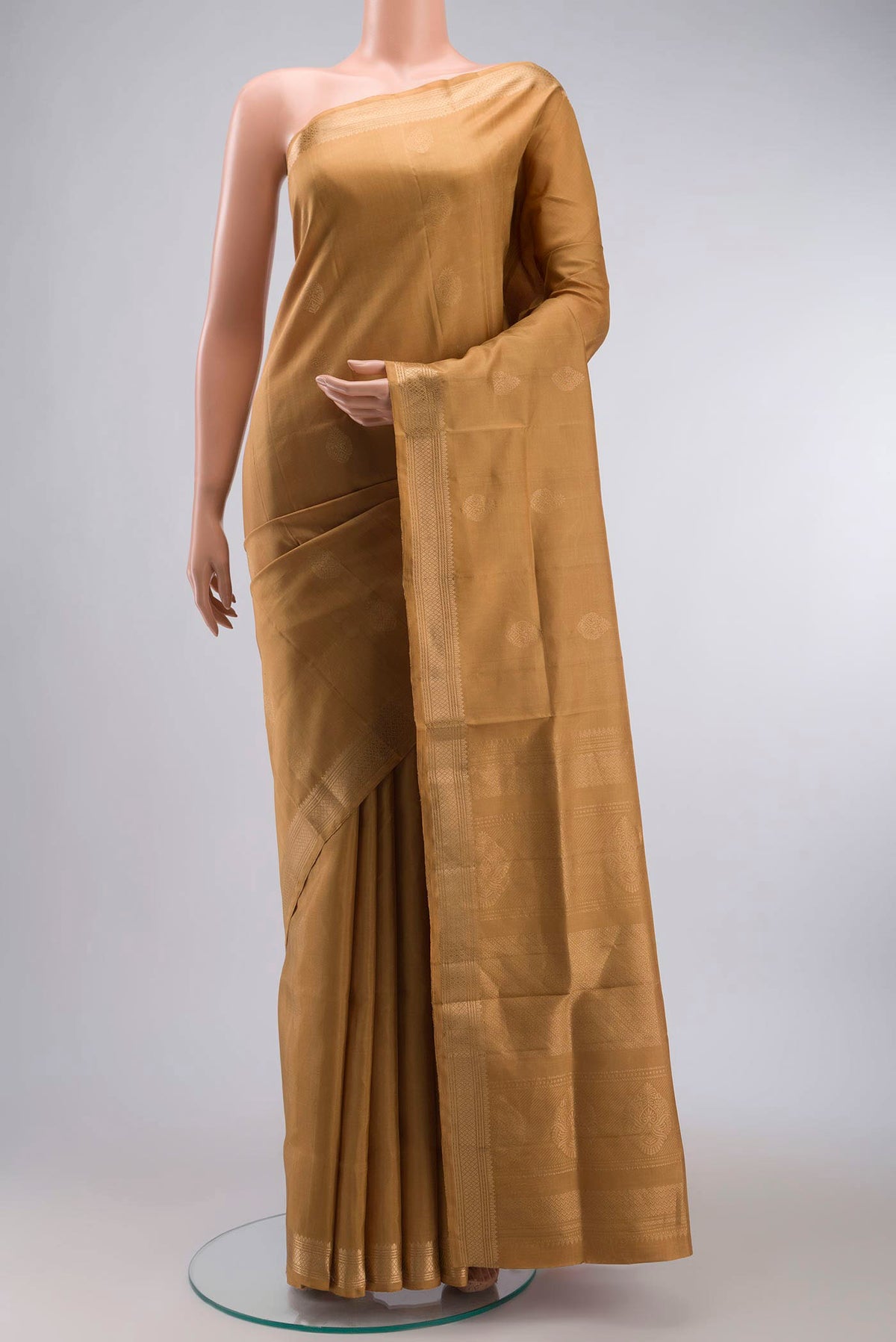 Brown Soft Silk Saree with Zari Butta on the body and Zari Border displayed on a mannequin