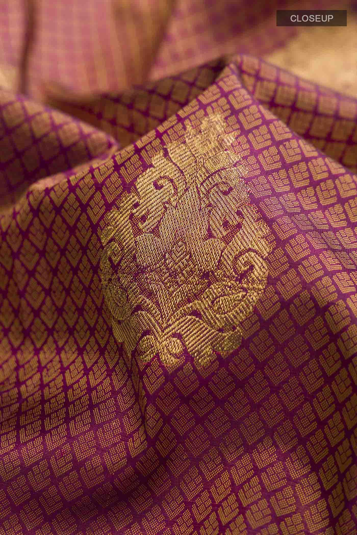 Close up of Maroon Kanchipuram Silk Saree with Jacquard With Zari Butta on the body and Zari Border displaying folds
