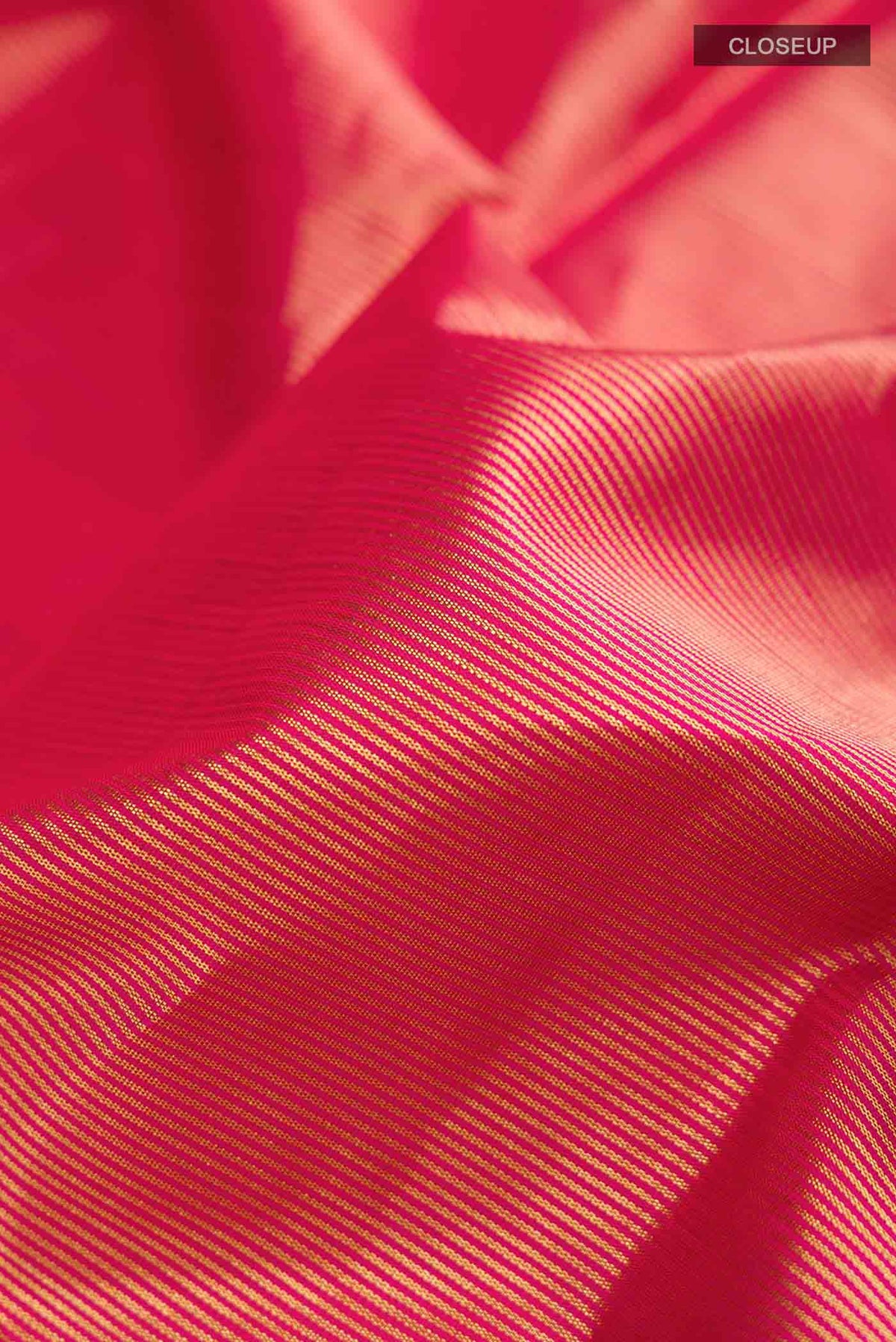 Close up of Red Kanchipuram Silk Saree with Stripes on the body and Plain Border displaying folds