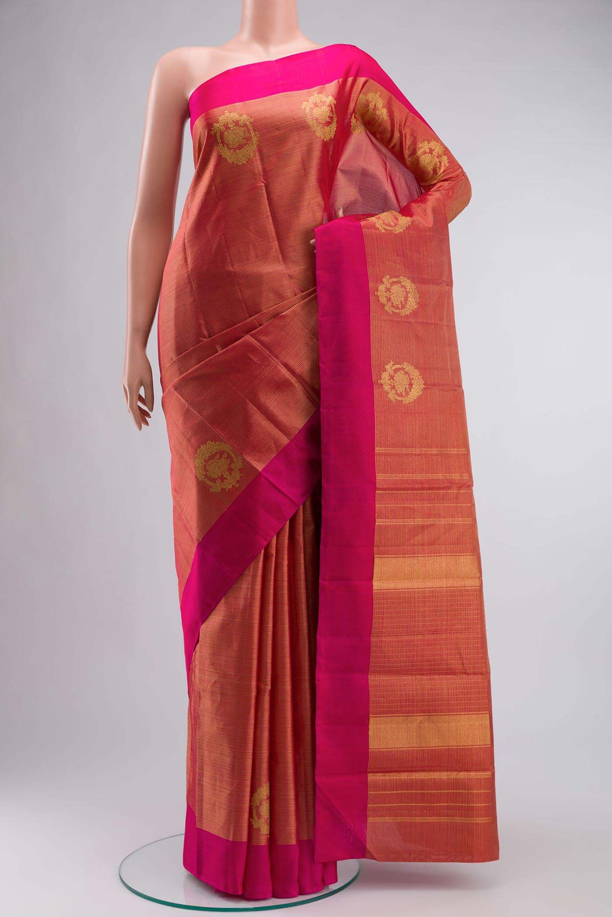 Red Kanchipuram Silk Saree with Stripes on the body and Plain Border displayed on a mannequin