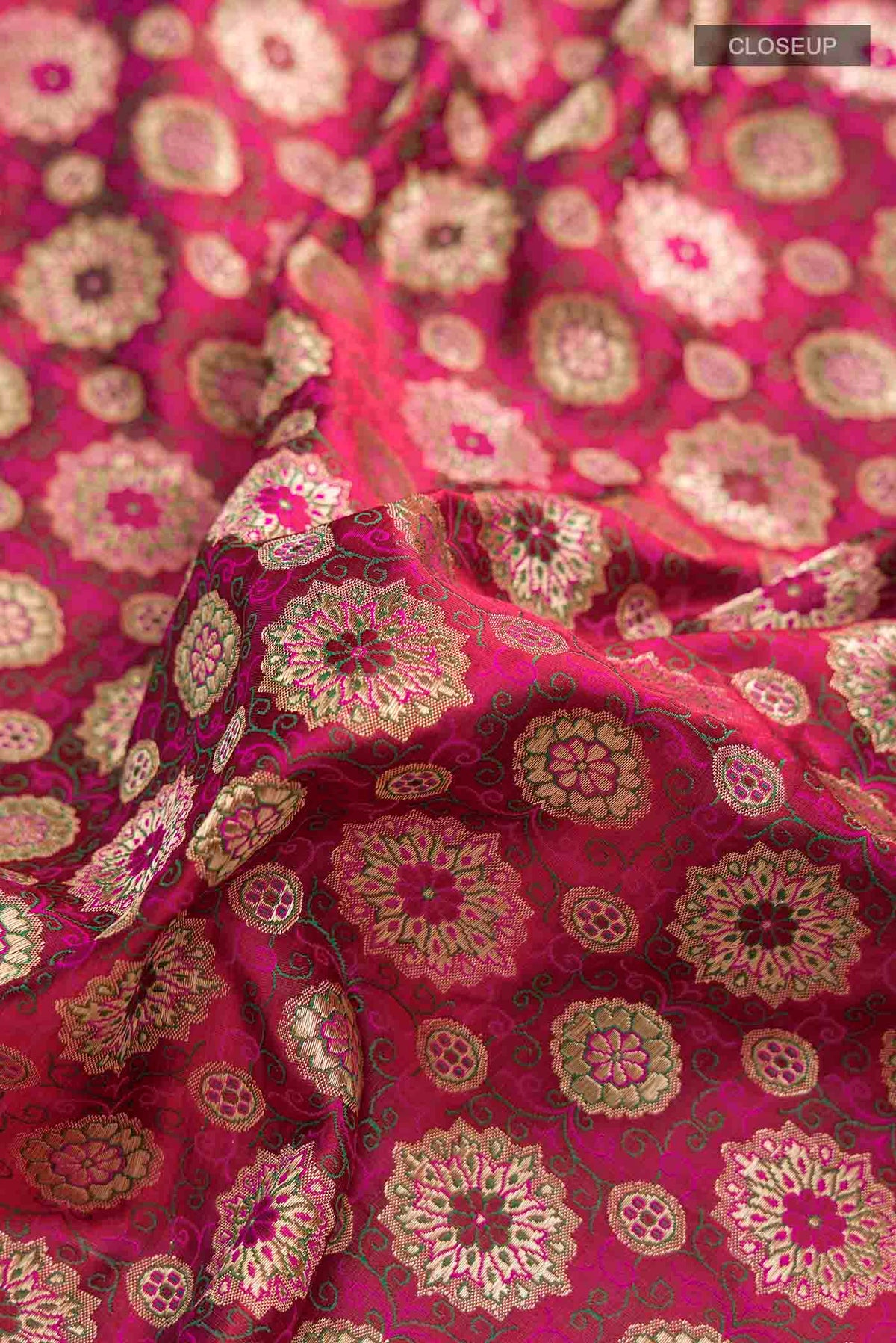 Close up of Pink Banarasi Silk Saree with Jacquard With Zari Butta on the body and Zari Border displaying folds