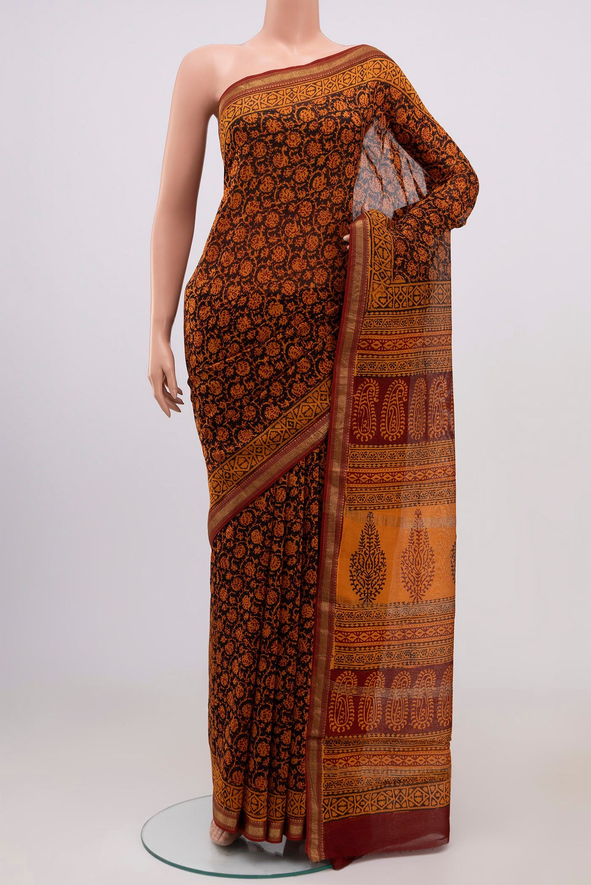 Brick Orange Maheshwari Silk Cotton Saree with Printed design on the body and Zari Border.  displayed on a mannequin
