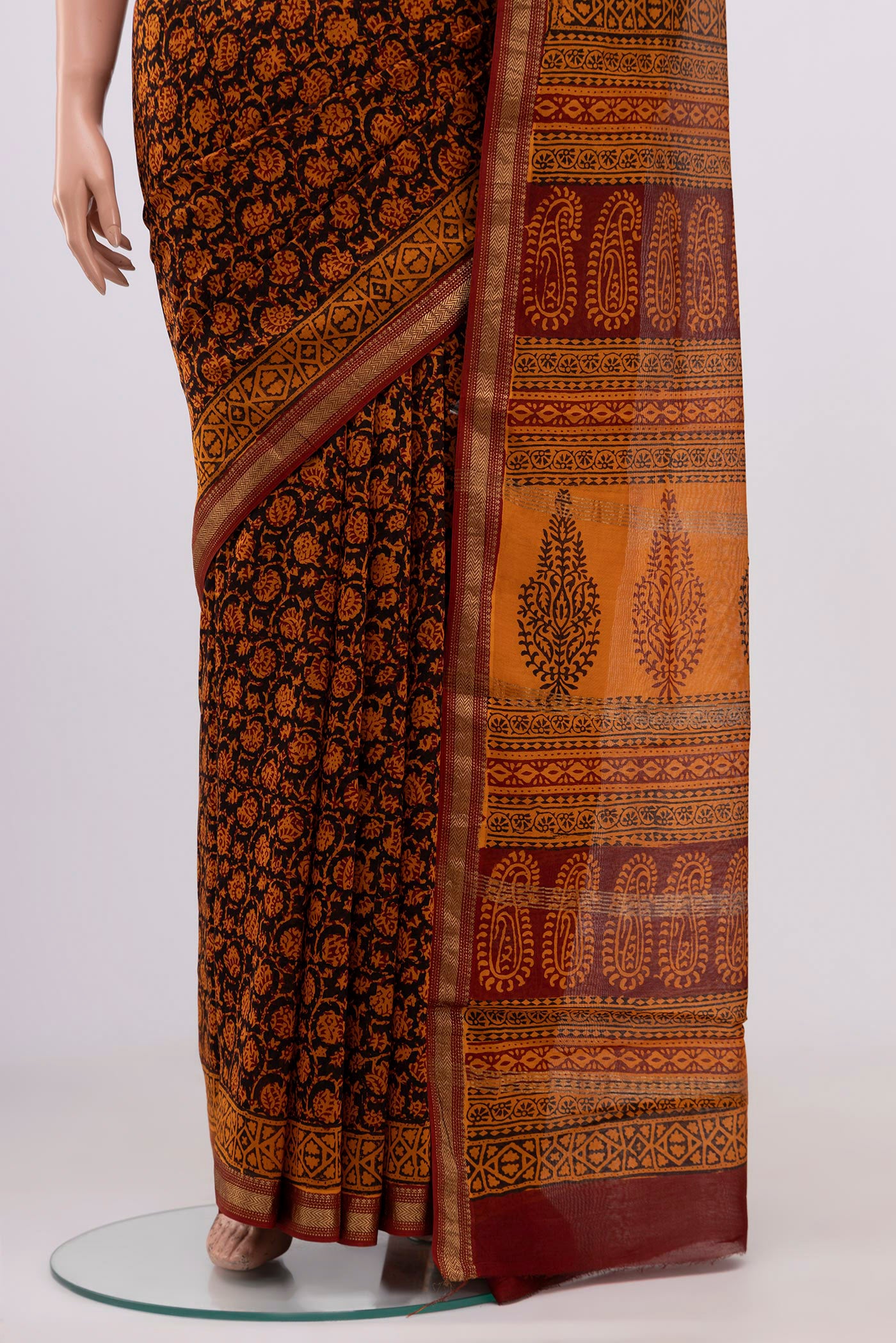 Pleats and pallu of Brick Orange Maheshwari Silk Cotton Saree with Printed design on the body and Zari Border. 