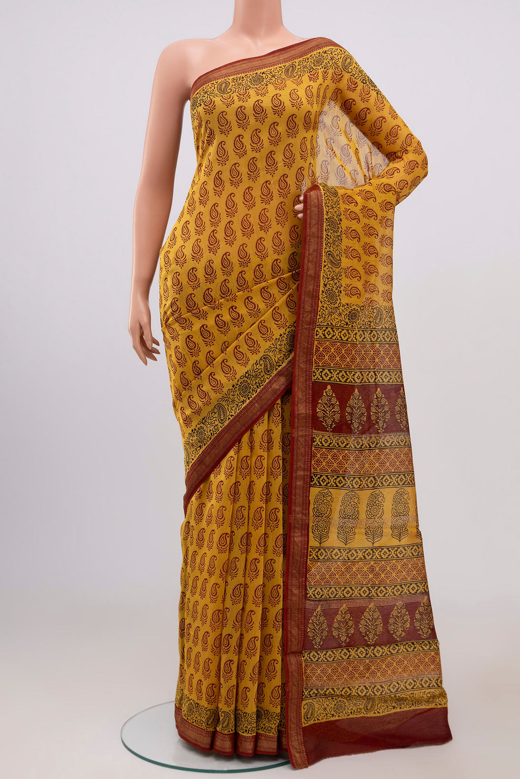 Yellow Maheshwari Silk Cotton Saree with Printed design on the body and Zari Border.  displayed on a mannequin