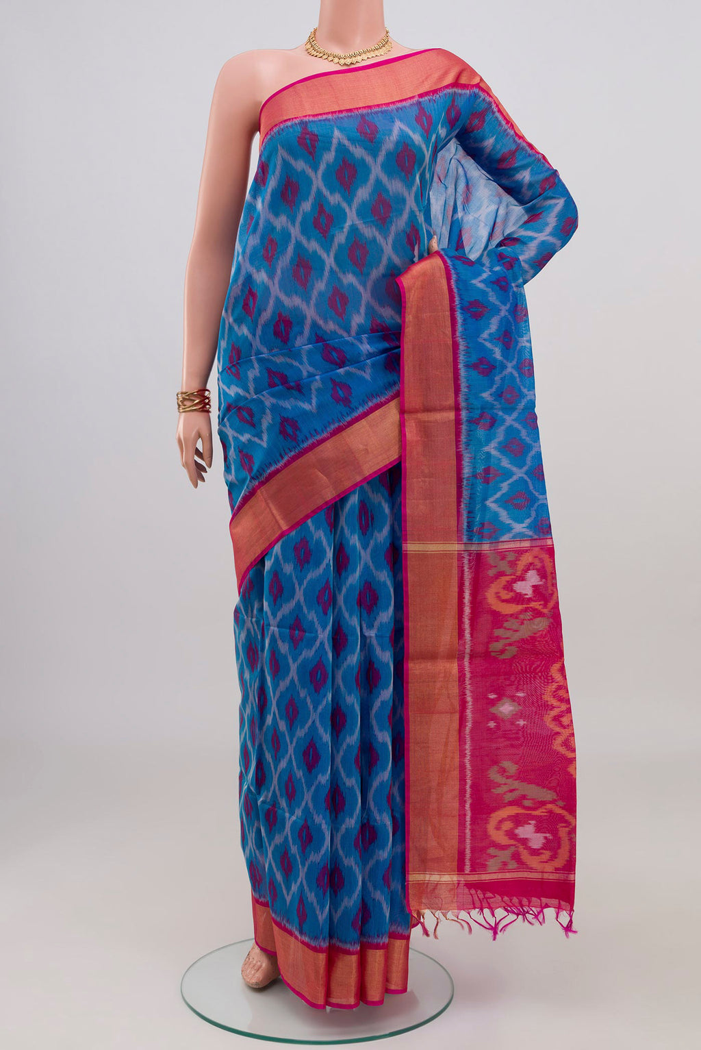 Blue Silk Cotton Saree with Ikat design on the body and Zari Border.  displayed on a mannequin