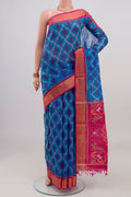 Blue Silk Cotton Saree with Ikat design on the body and Zari Border.  displayed on a mannequin