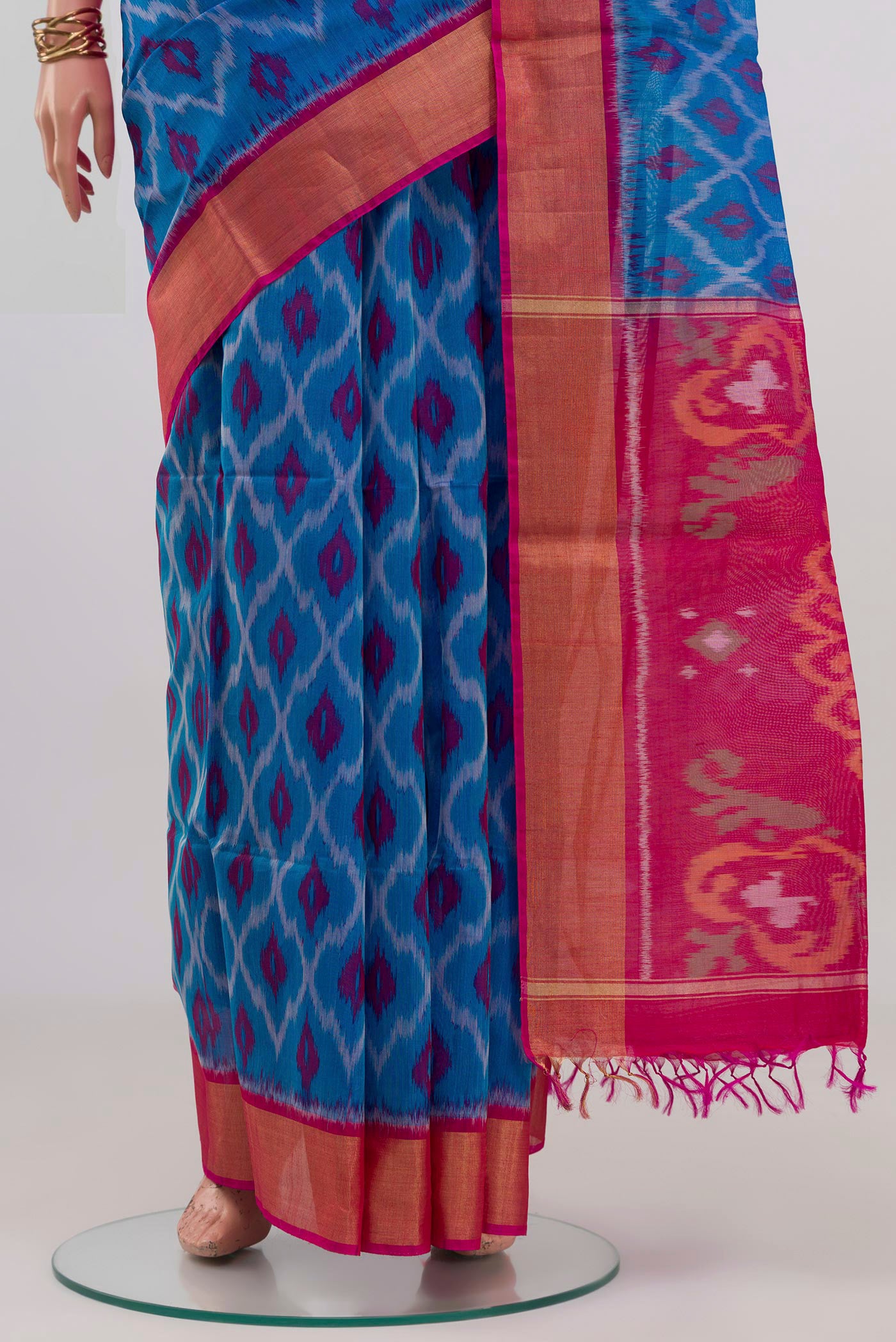 Pleats and pallu of Blue Silk Cotton Saree with Ikat design on the body and Zari Border. 