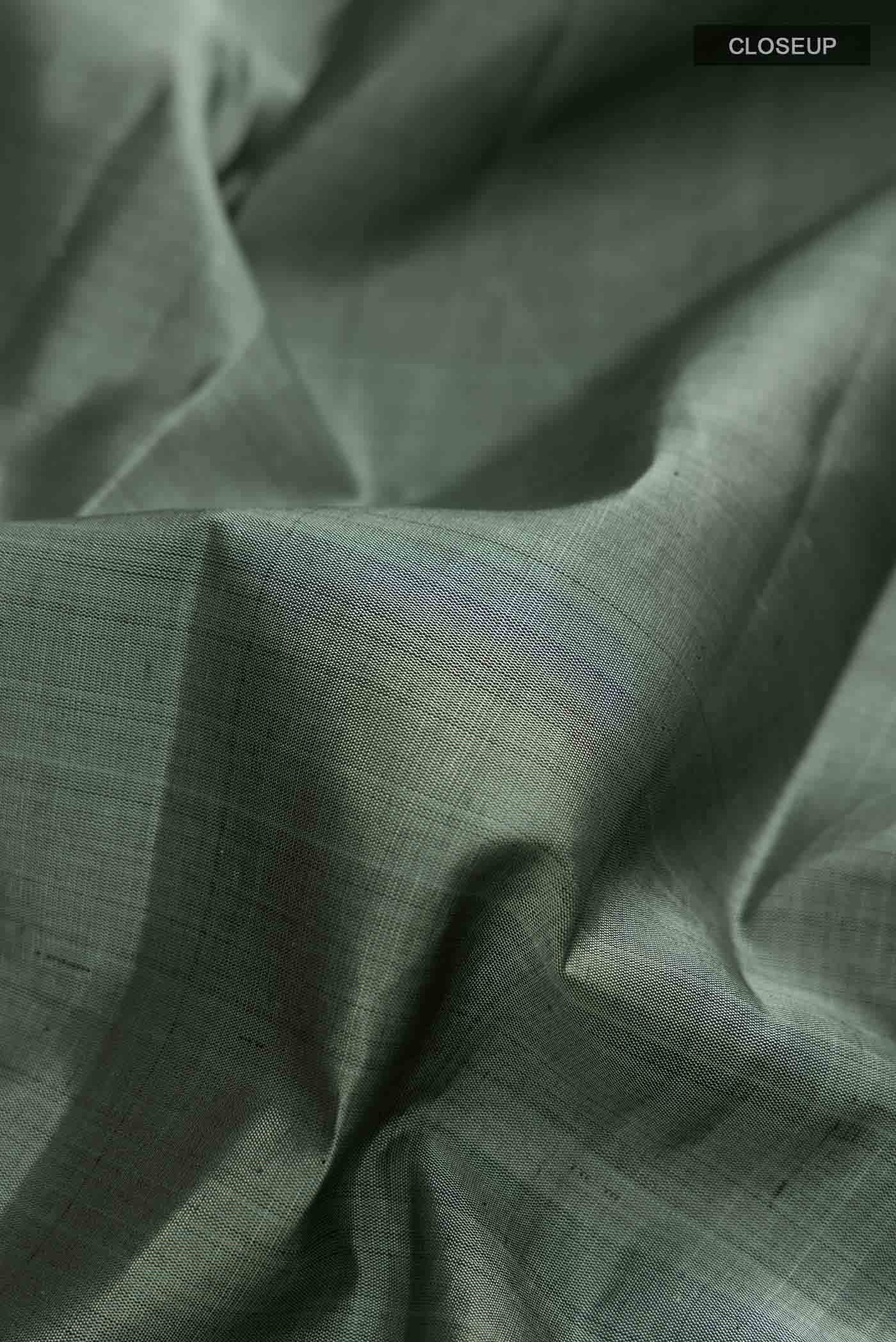 Close up of Grey Kanchipuram Silk Saree with Plain Body and Zari Border displaying folds