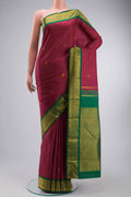 Magenta Kanchipuram Silk Saree with Zari Butta on the body and Zari Border displayed on a mannequin
