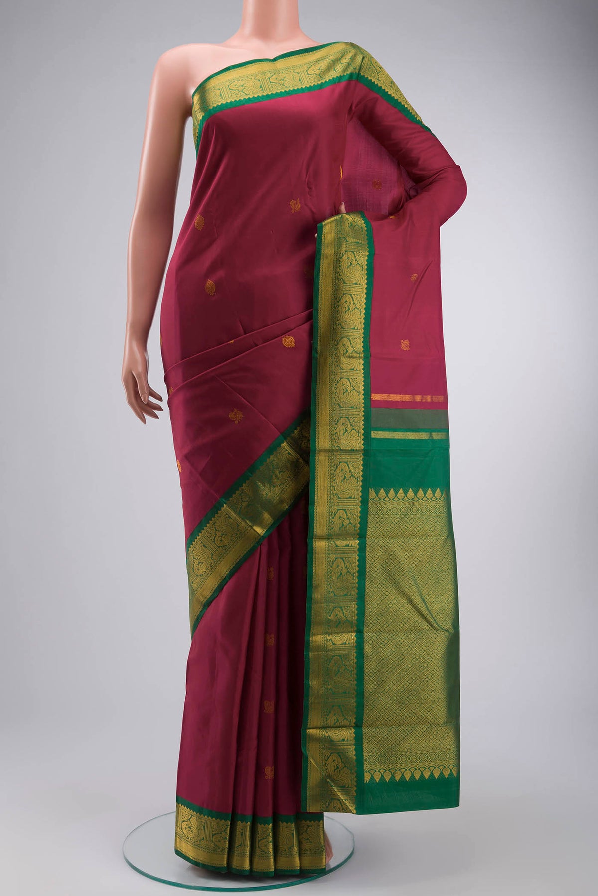 Magenta Kanchipuram Silk Saree with Zari Butta on the body and Zari Border displayed on a mannequin