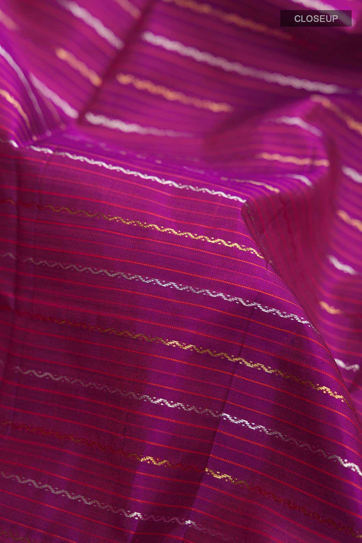 Close up of Pure Silk Pure Zari Purple Kanchipuram Saree Checked design on the body and Zari Border displaying folds