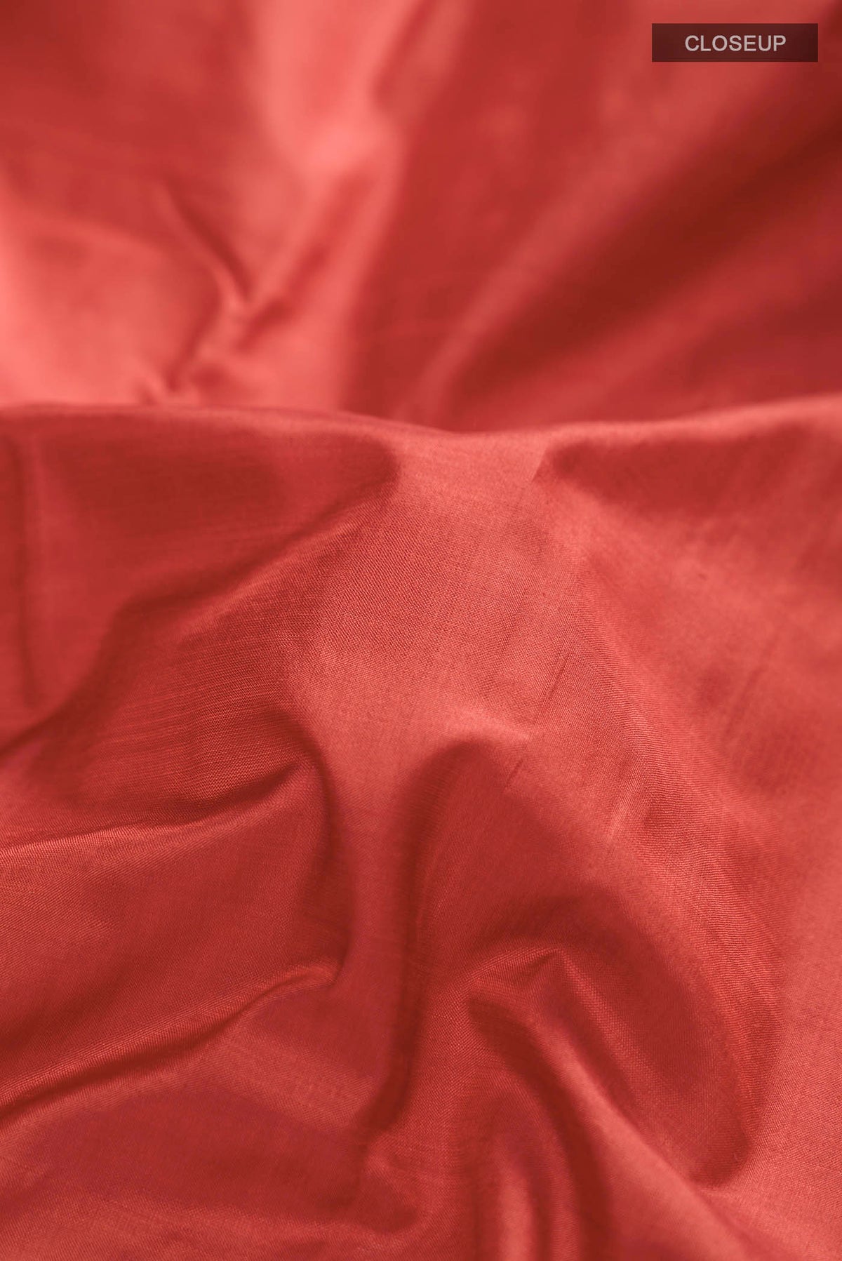 Close up of Rust Kanchipuram Silk Nine Yards Saree with Plain Body and Zari Border displaying folds