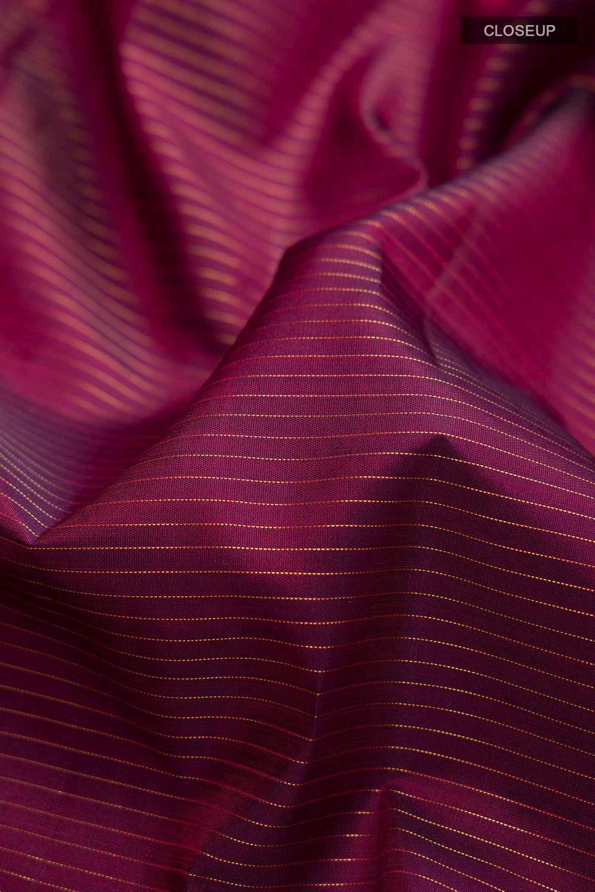 Close up of Maroon Kanchipuram Silk Nine Yards Saree with Stripes on the body and Zari Border displaying folds