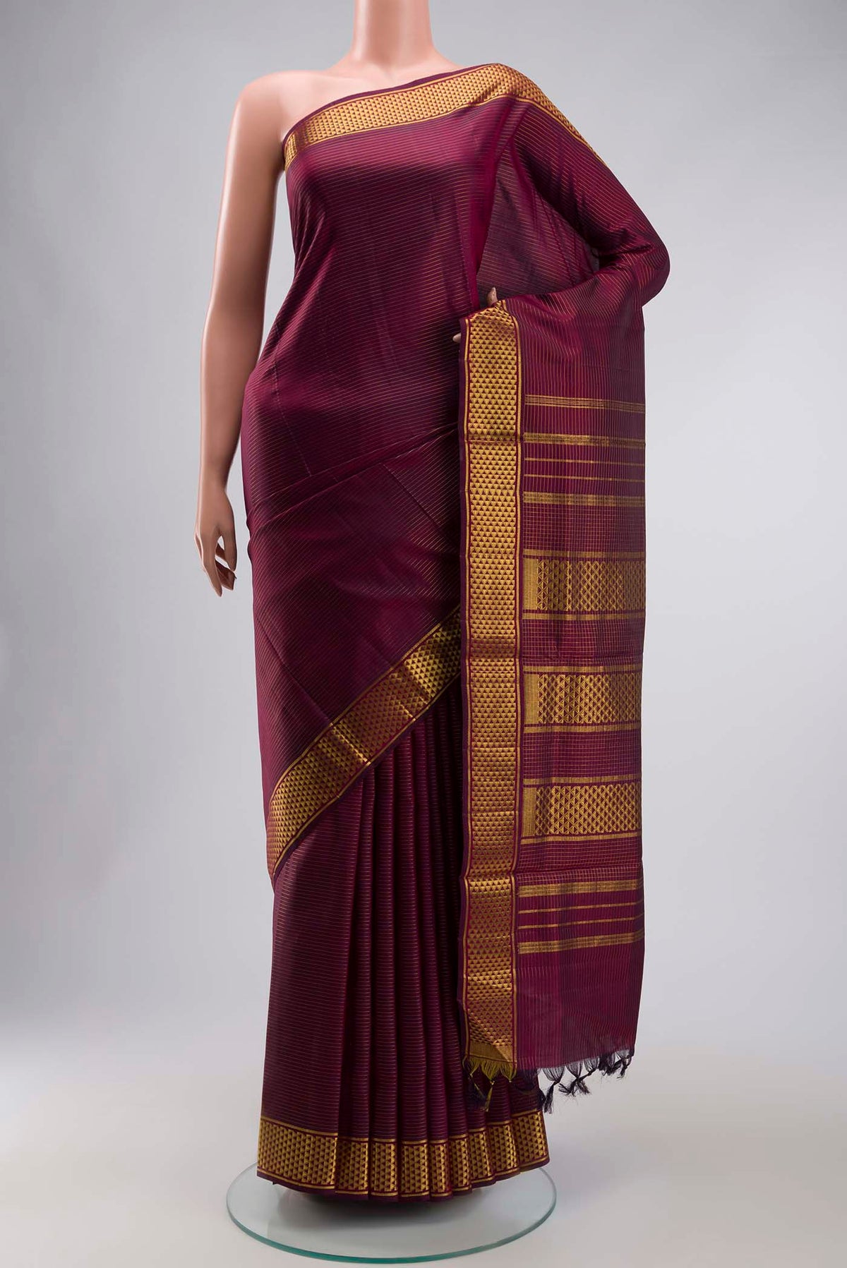 Maroon Kanchipuram Silk Nine Yards Saree with Stripes on the body and Zari Border displayed on a mannequin